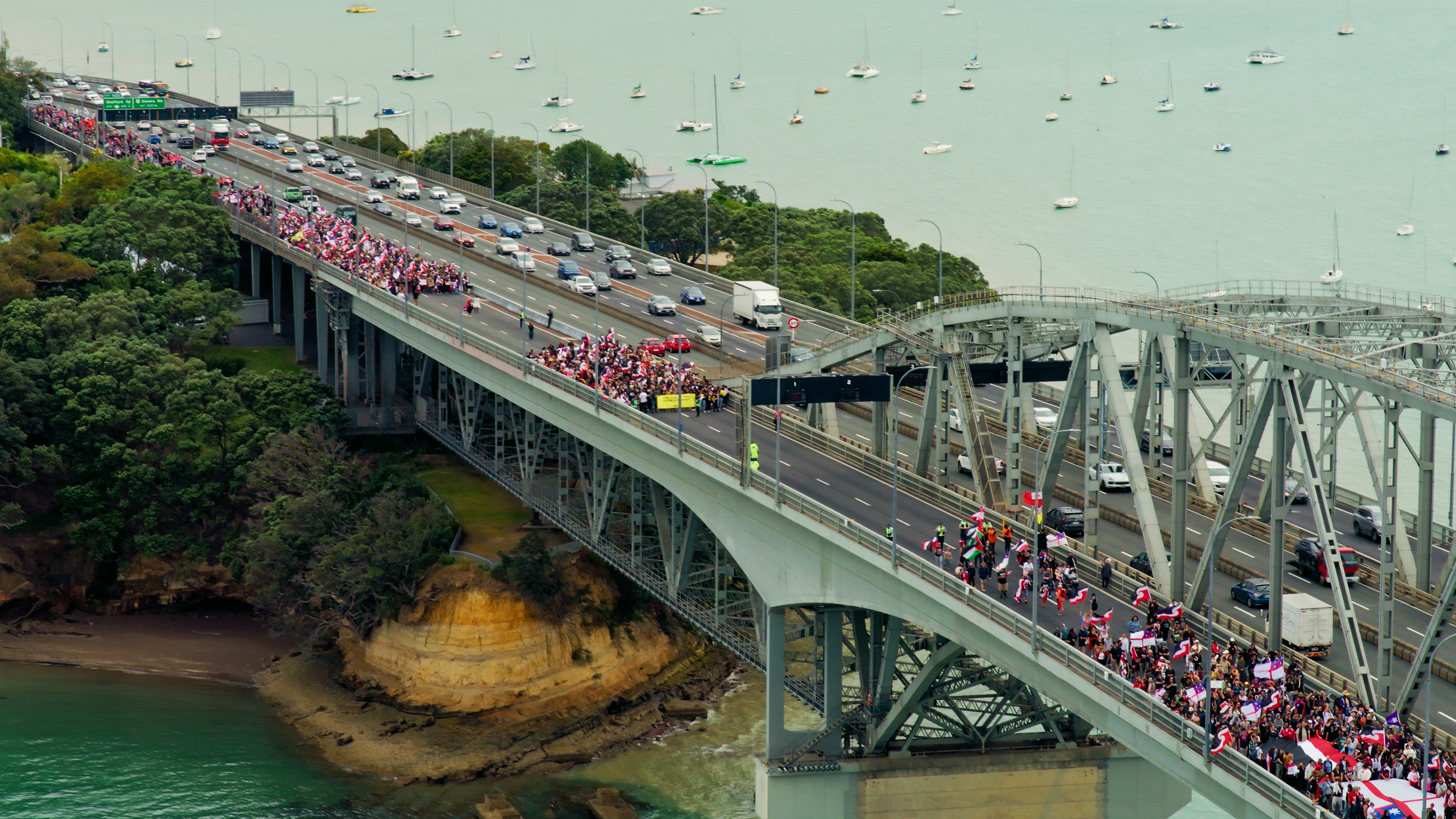 The Hīkoi mō Te Tiriti crosses the Auckland Harbour Bridge on day three of the hīkoi, which is making its way to Parliament in protest of the Government's Treaty Principles Bill.
Photo / Greenpeace Aotearoa