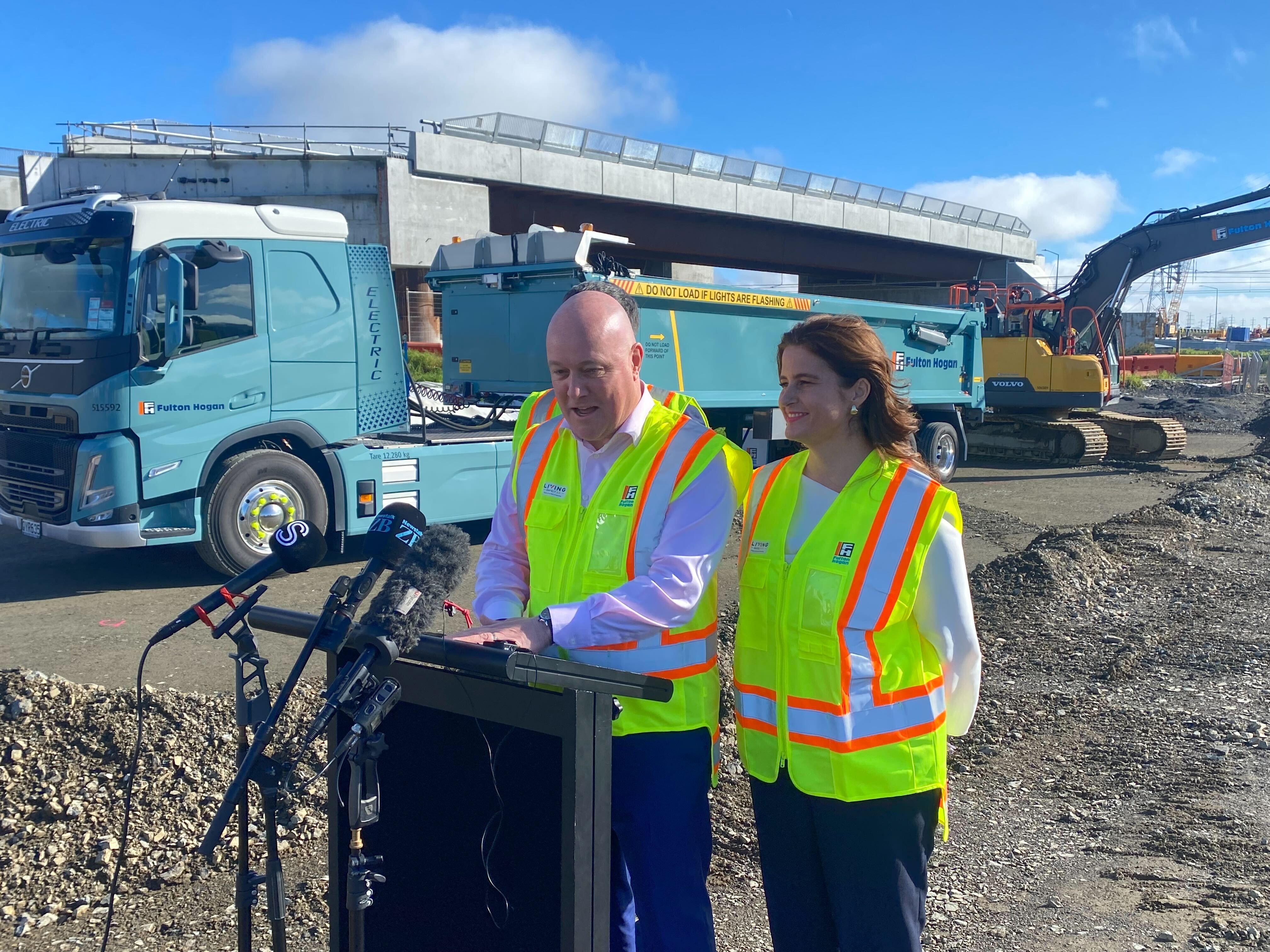 Prime Minister Christopher Luxon (left, front), Economic Growth Minister Nicola Willis (right) and Infrastructure Minister Chris Bishop (obscured) speak to media in Auckland. Photo / Raphael Franks