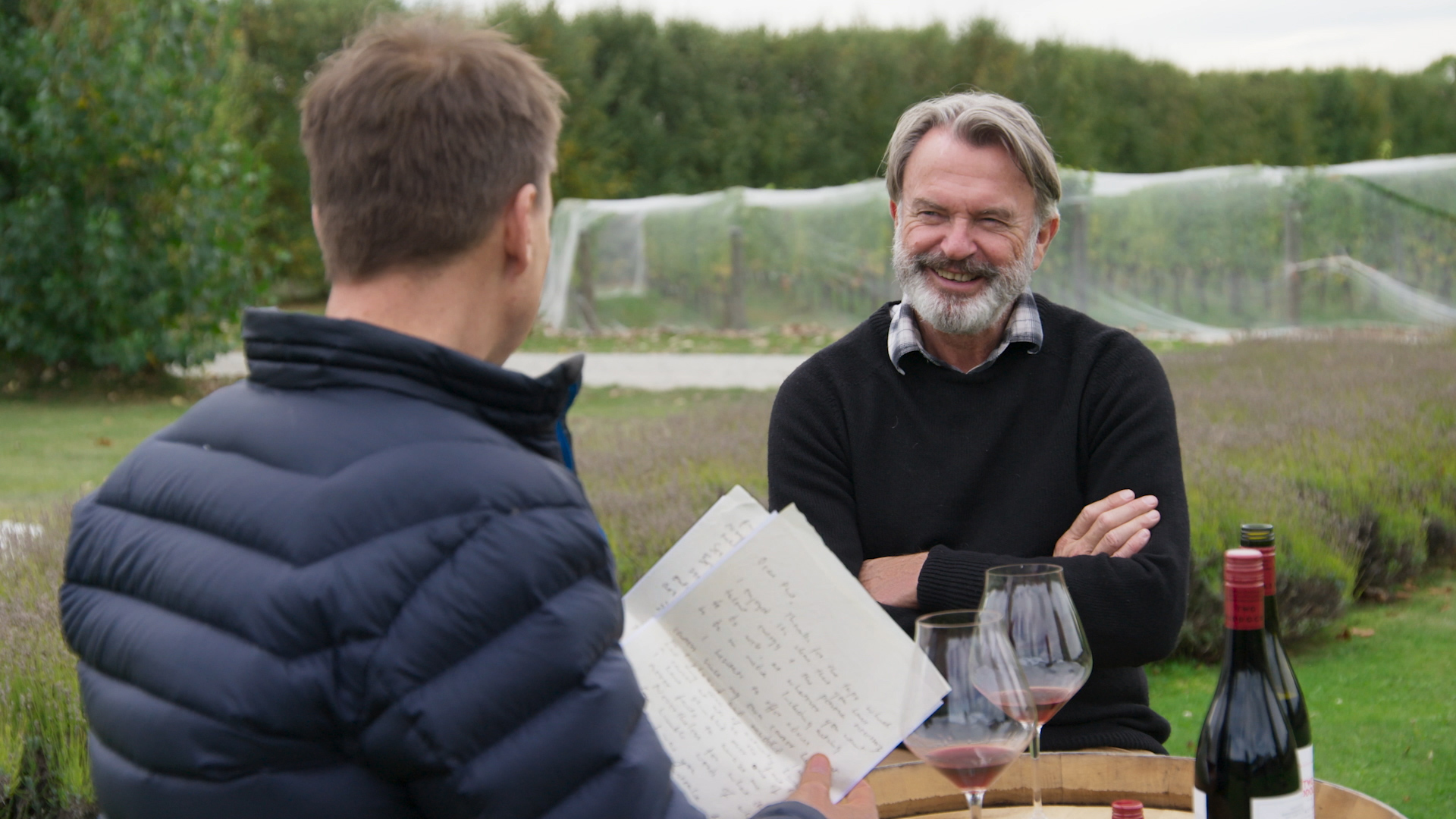 Keoghan and Sam Neill sample the grapes.