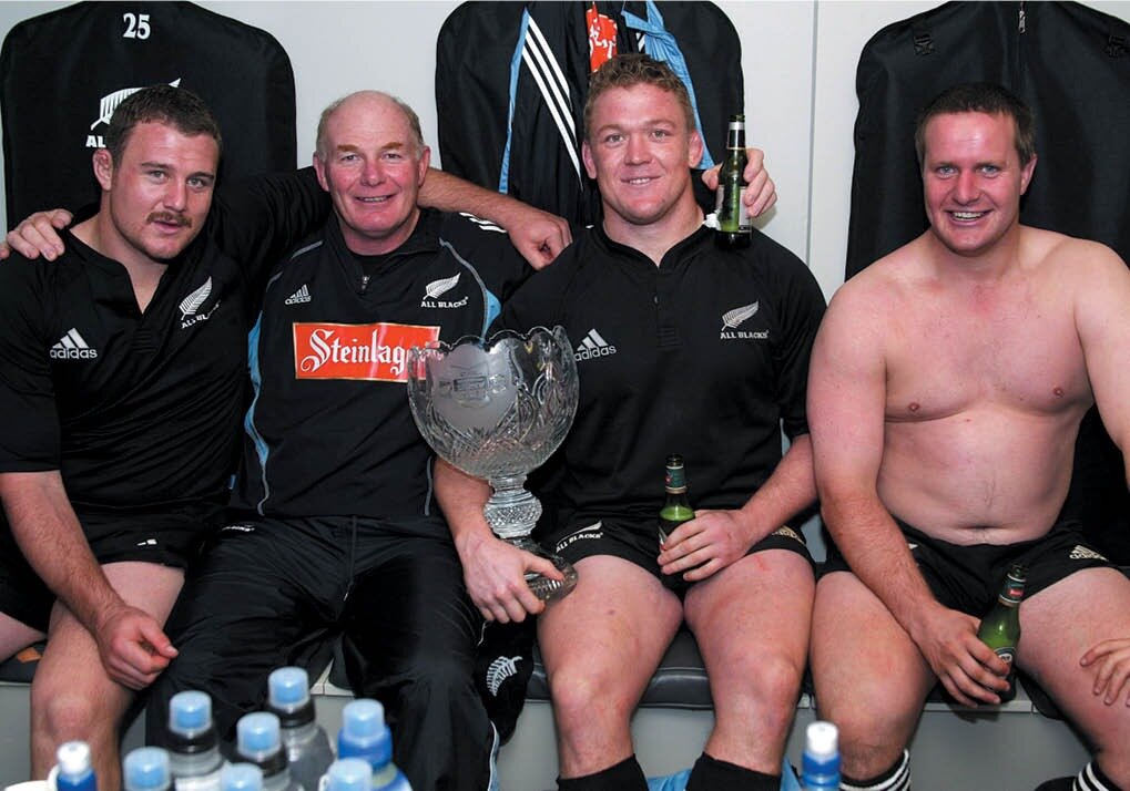Mike Cron poses in the All Blacks sheds with props Tony Woodcock, l to r, Greg Somerville and Campbell Johnstone after the 3-0 series win over the 2005 British & Irish Lions. Photo / Supplied