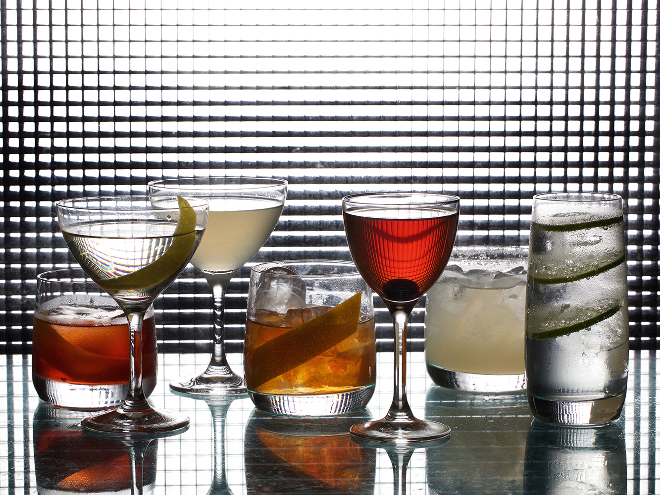 Seven essential cocktails, from left: Negroni, Martini, Daiquiri, Old-Fashioned, Manhattan, Margarita, and Gin and Tonic. Picture / Supplied