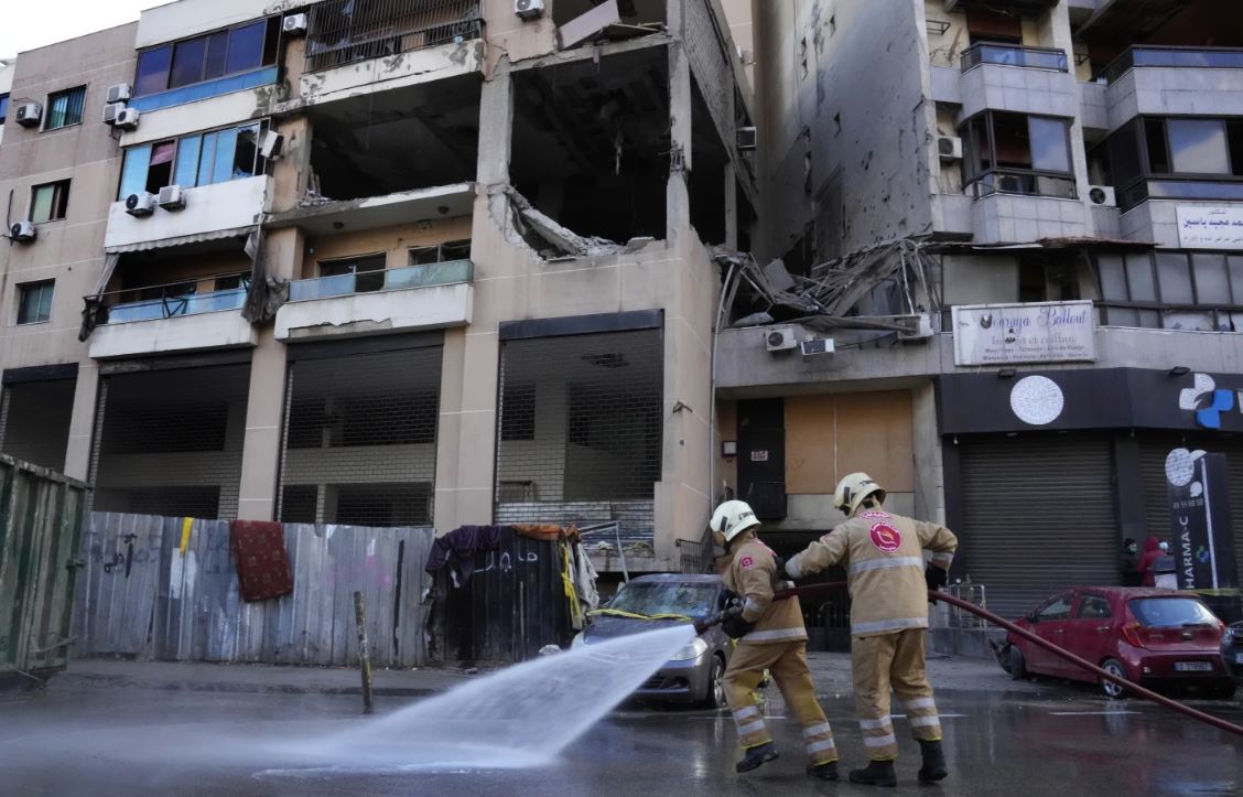 Civil defence workers clean the street in front of an apartment building where an apparent airstrike killed top Hamas political leader Saleh Arouri. Photo / AP