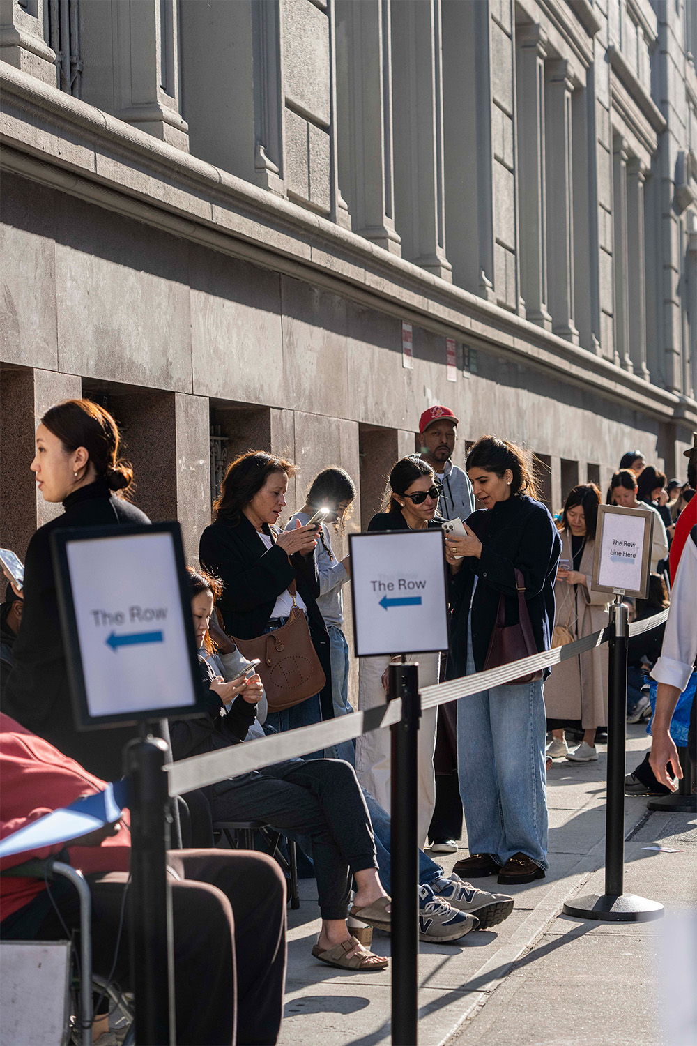 People wait in line outside the Row in New York. Photo / New York Times