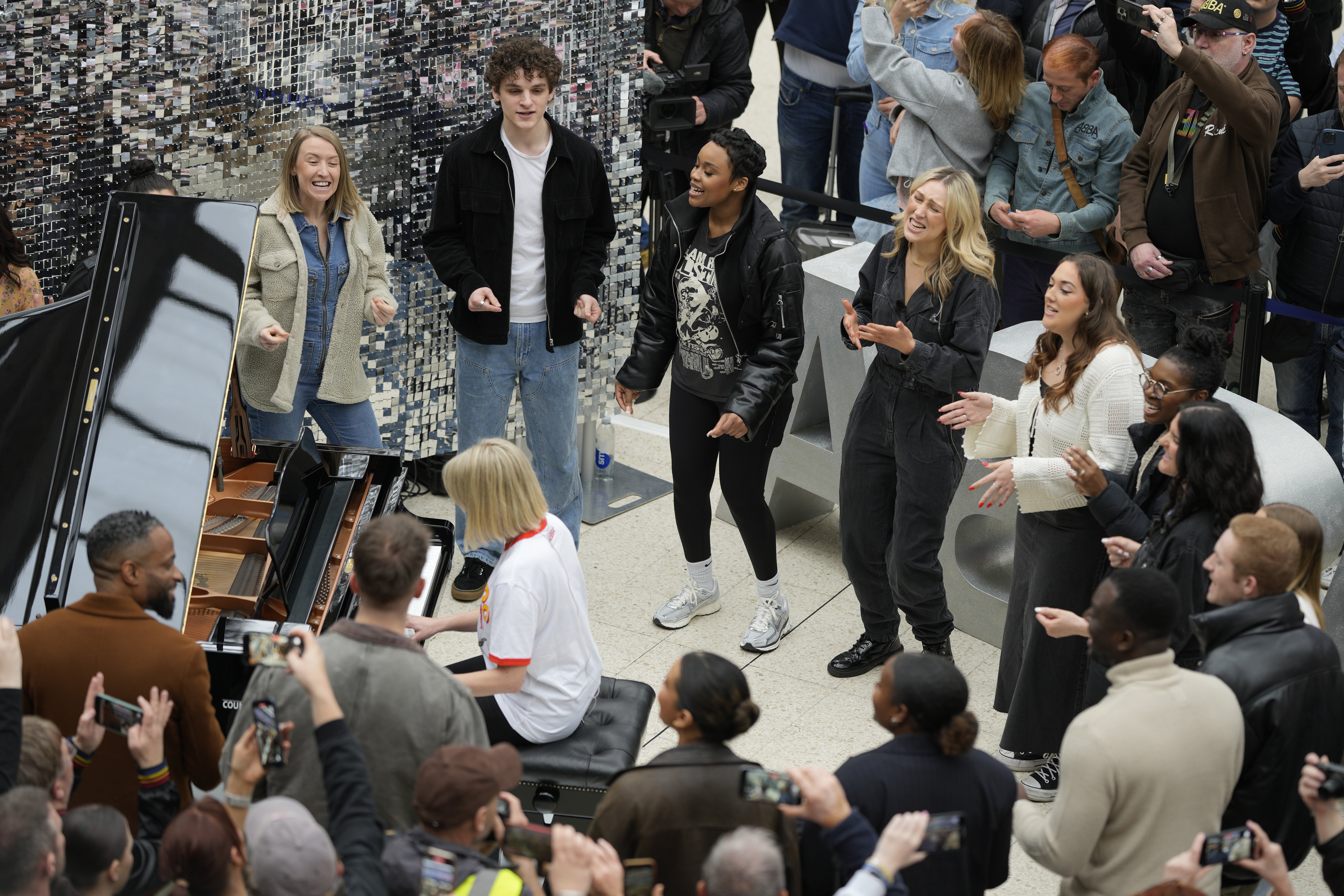 Members of the Mark de Lisser singers preform the iconic ABBA song 'Waterloo' at Waterloo Station in London on Saturday. Photo / AP