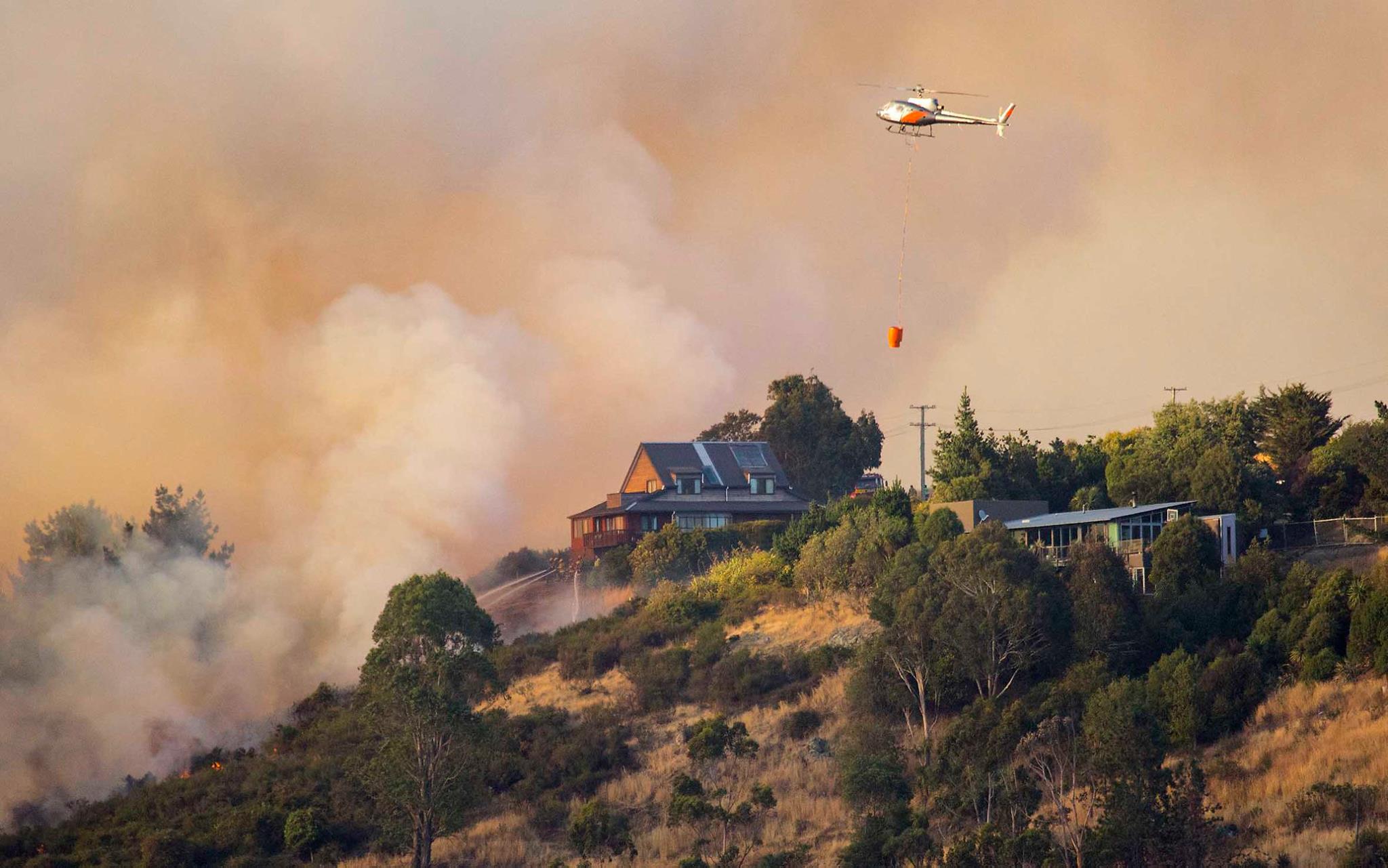 A helicopter fighting the fires on the Port Hills on February 16, 2017. Photo / Supplied