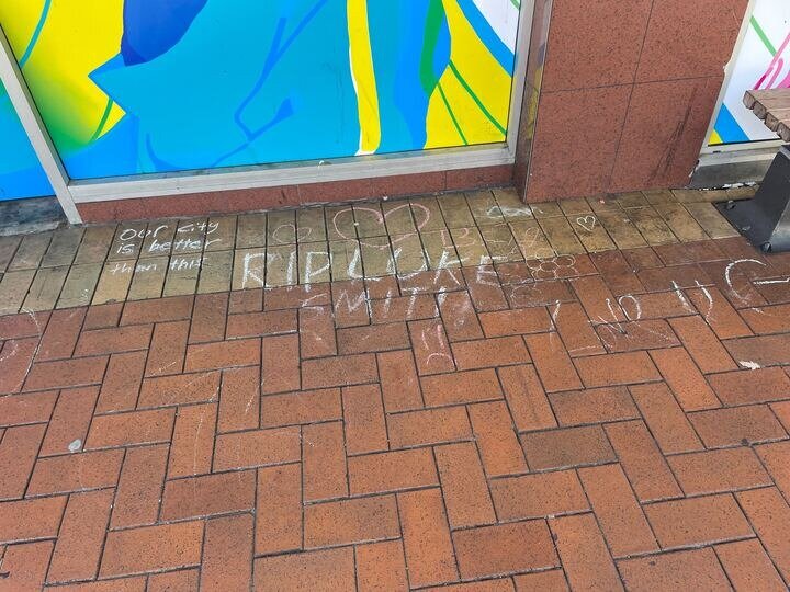 Chalk tributes to Luke Smith have been left outside the old Reading Cinema complex on Courtenay Place, Wellington. Photo / Azaria Howell