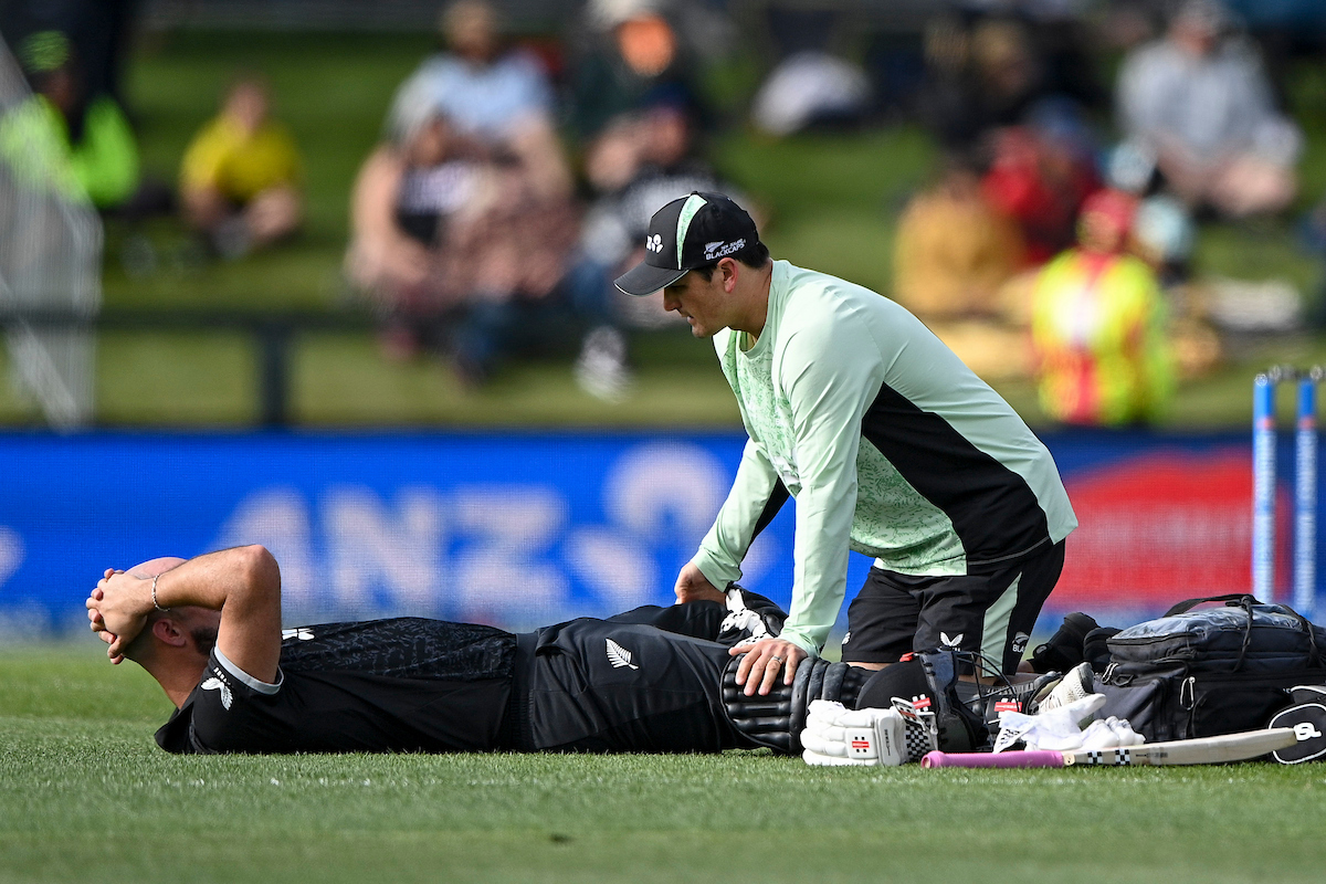 Daryl Mitchell is treated by the Black Caps' physio during the first ODI against the West Indies. Photo / Photosport