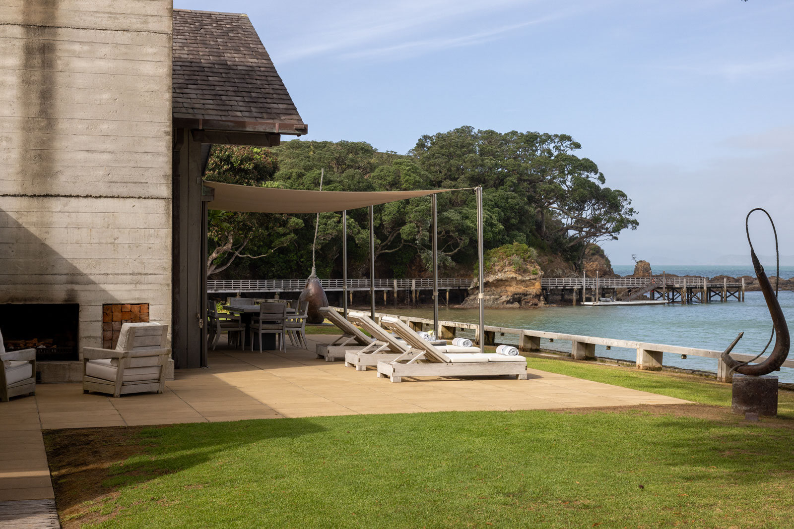 The Boathouse with the private jetty beyond. The bronze sculptures are by Paul Dibble. Photo / Simon Devitt