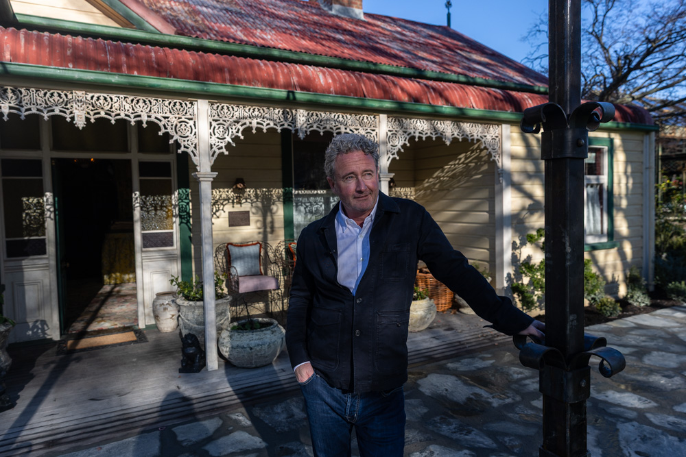 Chris Meehan stands outside the restored farmhouse. Photo / Jason Dorday