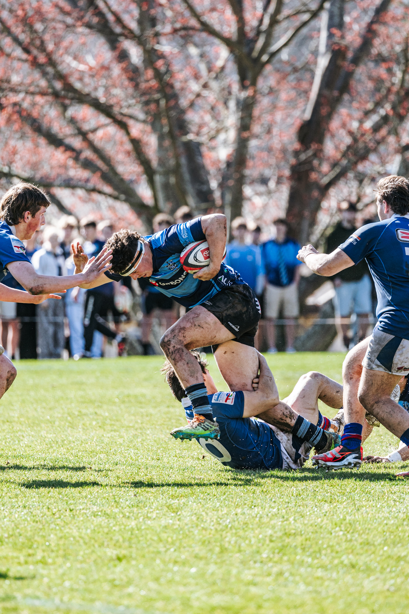 A Nelson College forward carries the ball through the tackle of Mika Muliaina of Southland Boys' High School. Photo / Tasman Rugby Union