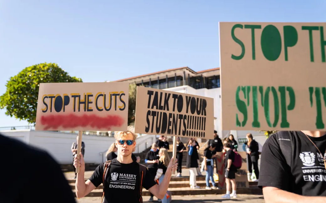 Students mount a protest outside the Albany campus of Massey University, which last week decided to cut more than 60 positions at its College of Sciences. Scientists fear the turmoil seen across universities will have long-lasting impacts. Photo / Niklas Polzer