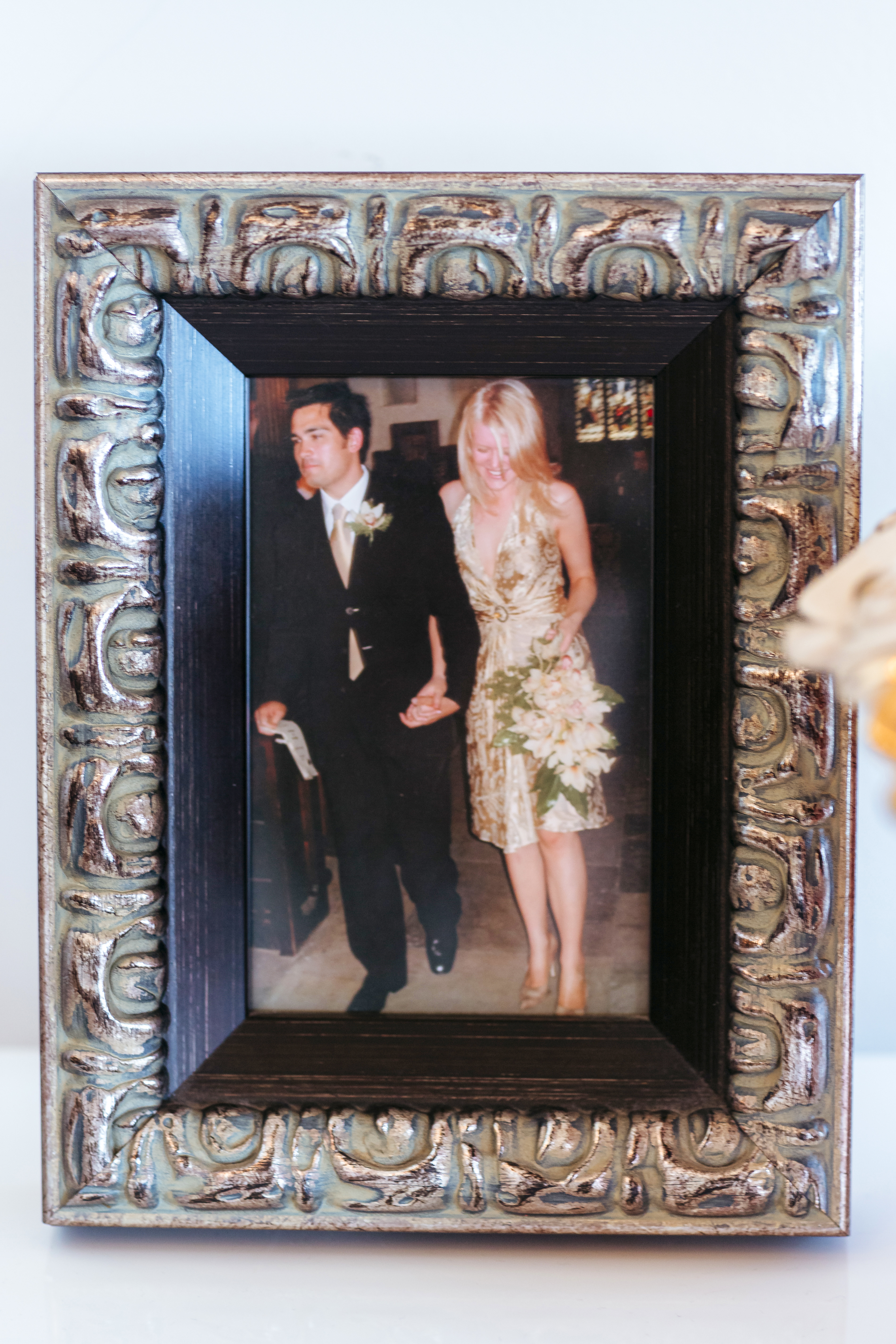 The bride wore a gold cocktail dress and the groom wore an old work suit.