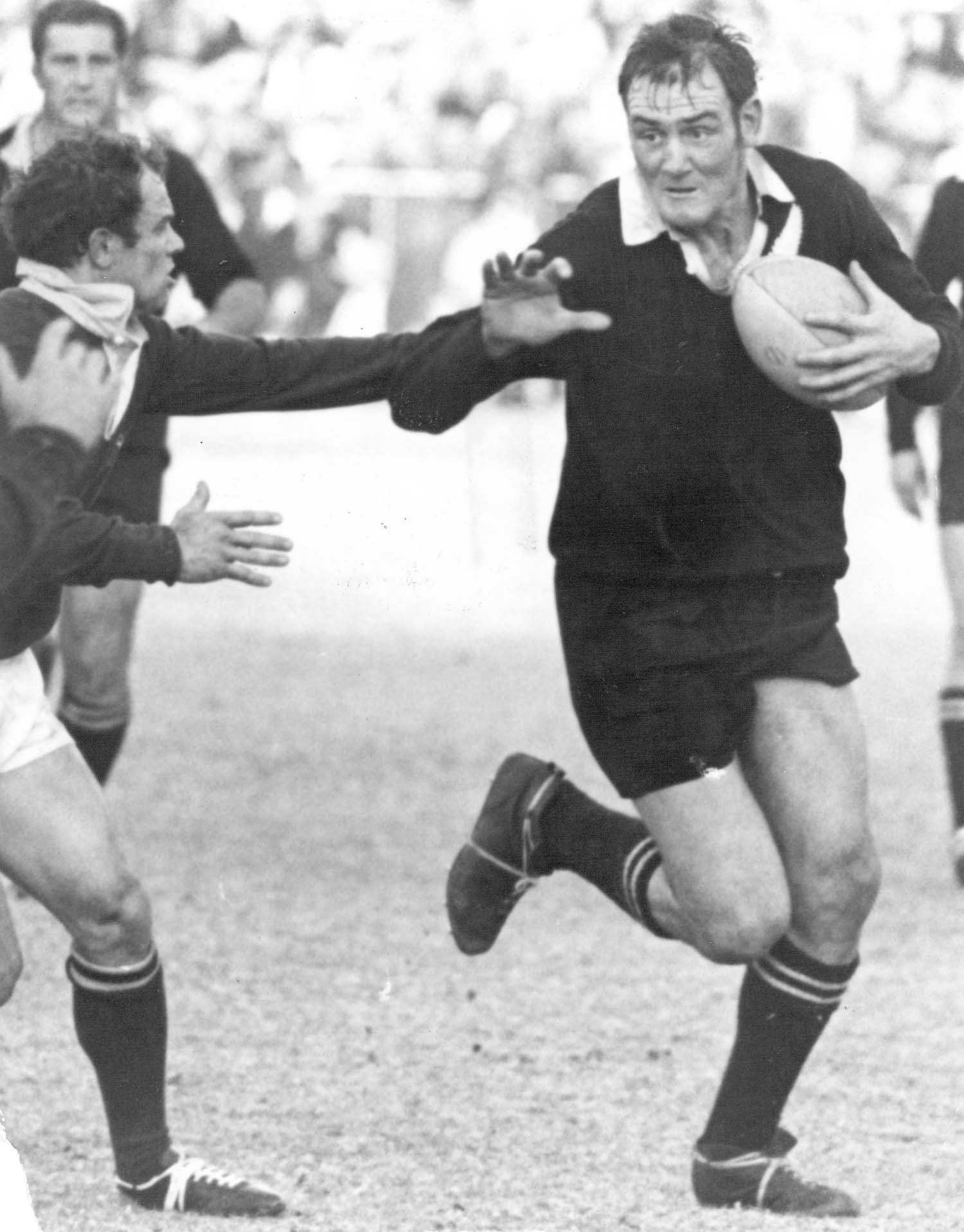 Brian Lochore tries to hand off Mannetjies Roux, South Africa, 1970. Photo / Photosport