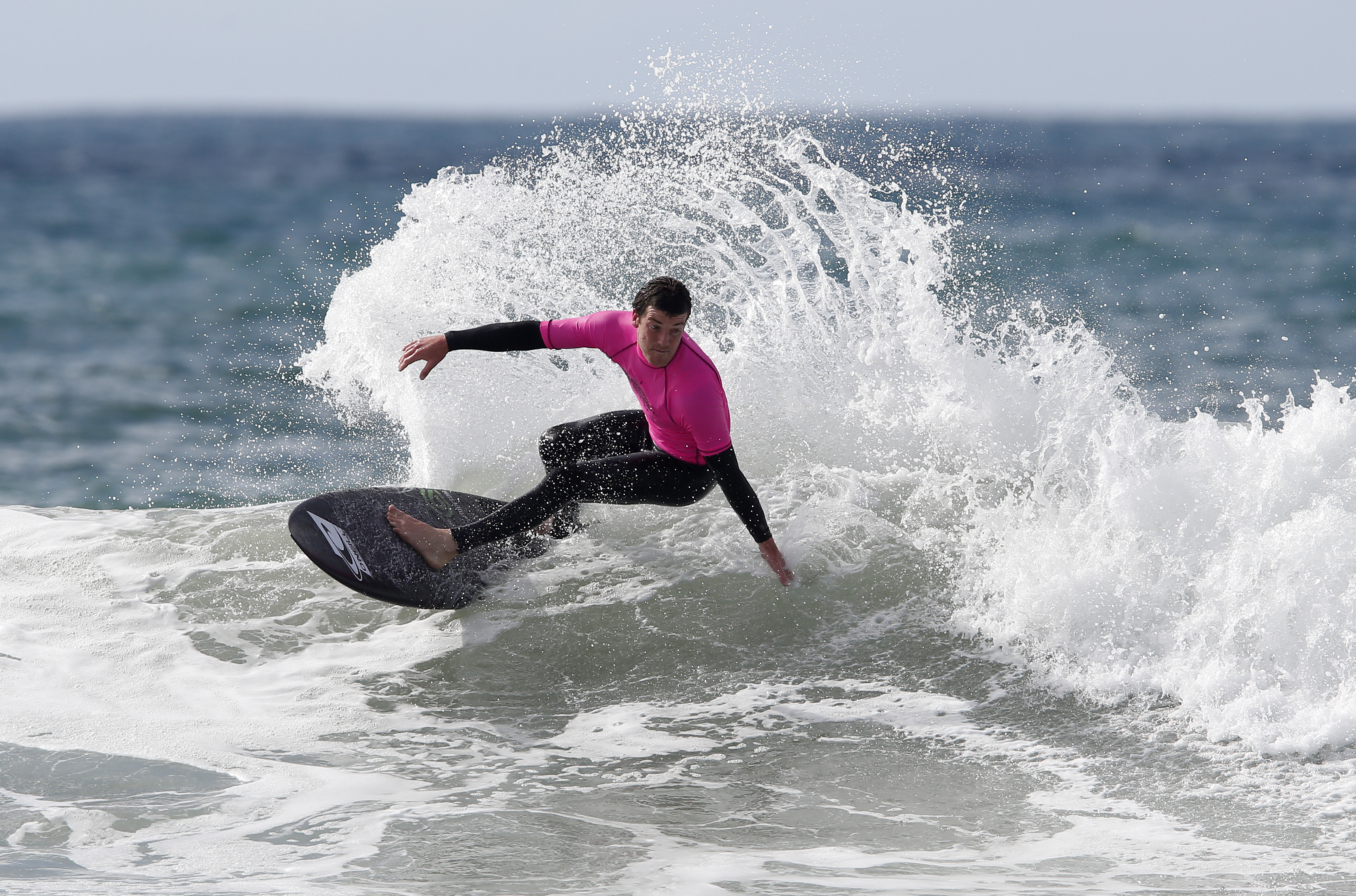 Paul Moretti catches a wave at Sandy Bay during the 2022 Polar Bear surf competition, an annual event at one of the best beaches in Northland. Photo /  Michael Cunningham.