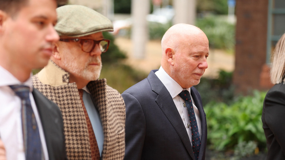 Phillip Polkinghorne, right, arrives at the High Court at Auckland with his lawyers. He's accused of having murdered wife Pauline Hanna and staged her death as a suicide. Photo / Michael Craig