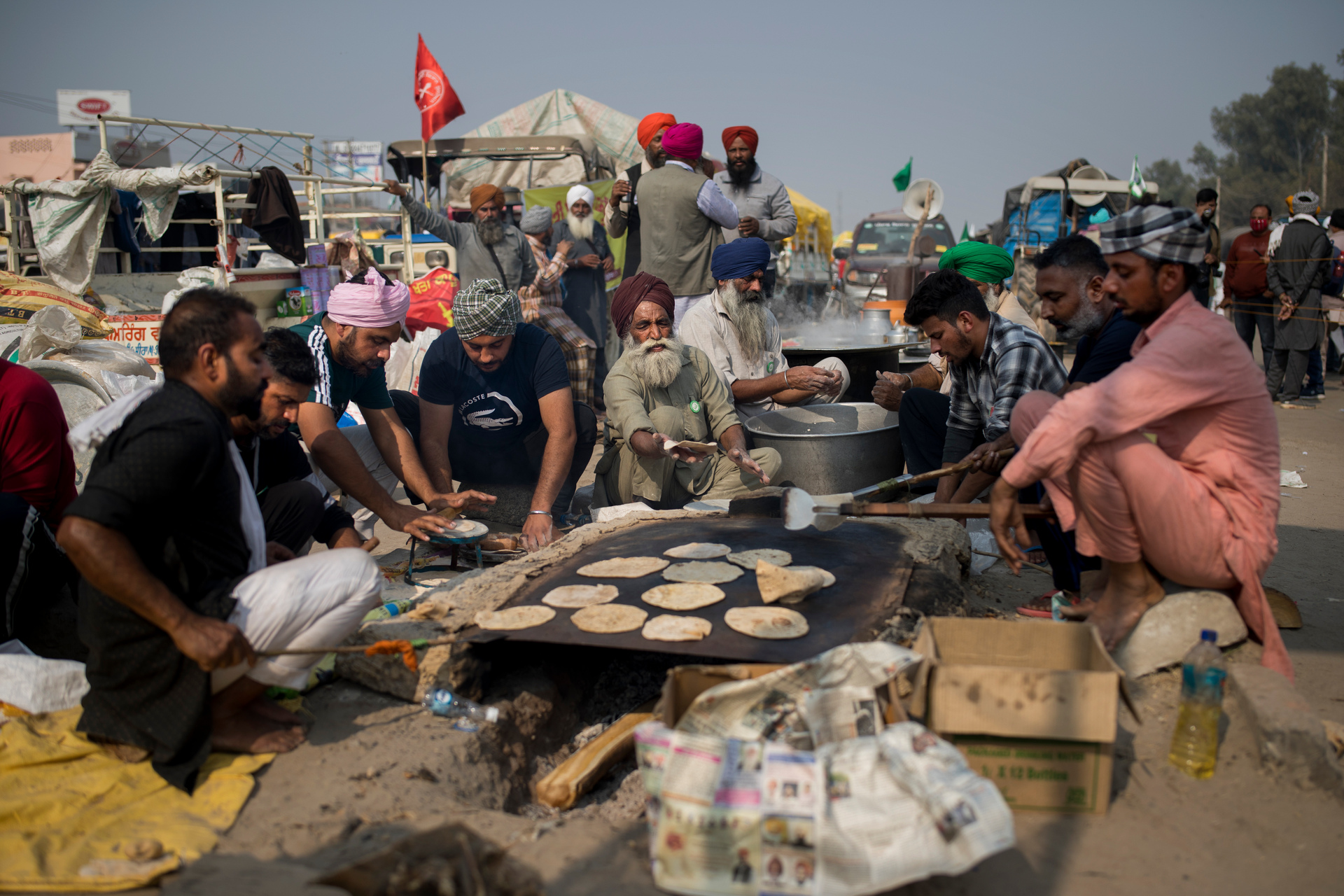 Protesting farmers prepare food for themselves as they block a major highway protesting against the new farm laws. Photo / AP