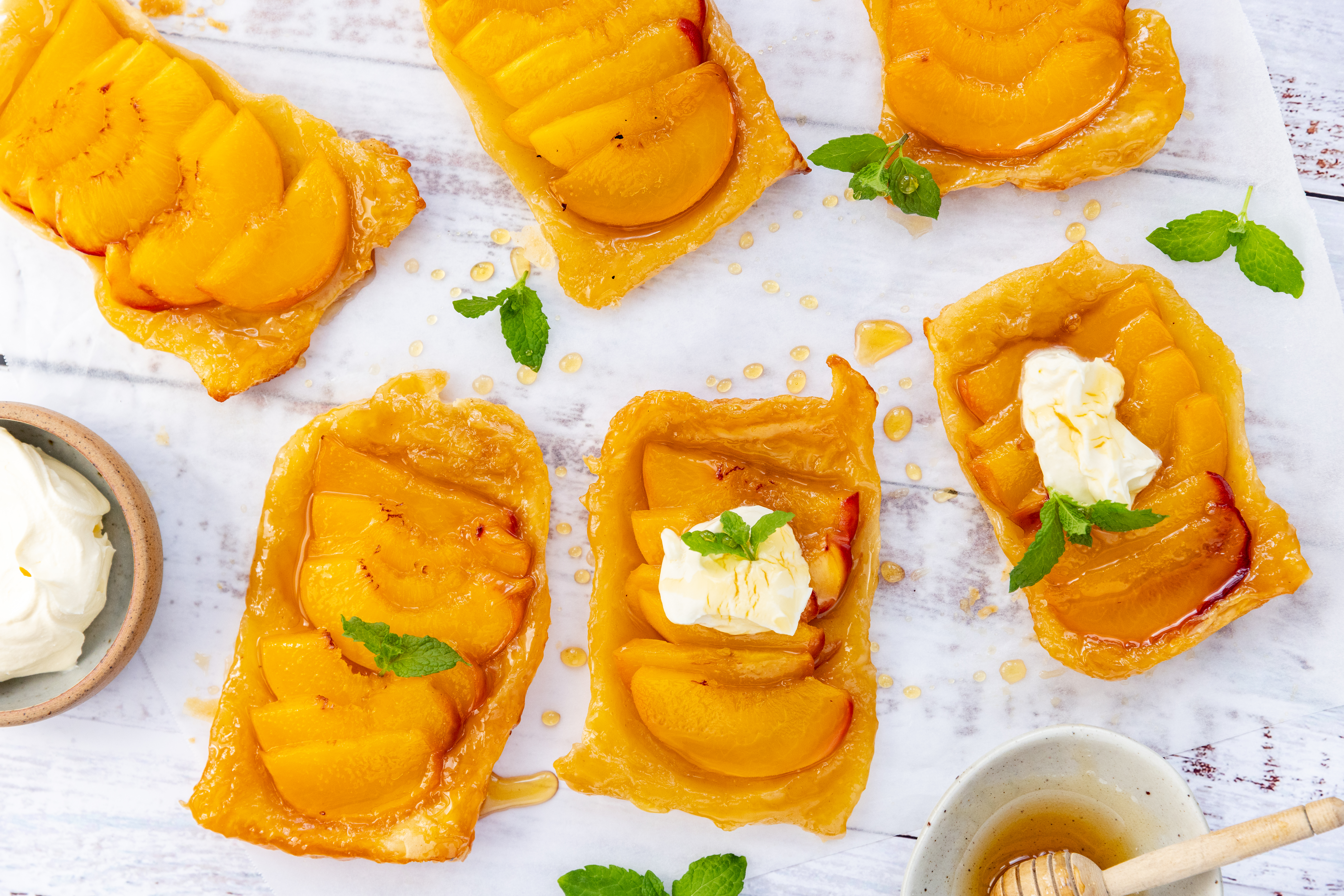 Peaches and puff pastry combine to create these simple tarts. Photo / Babiche Martens