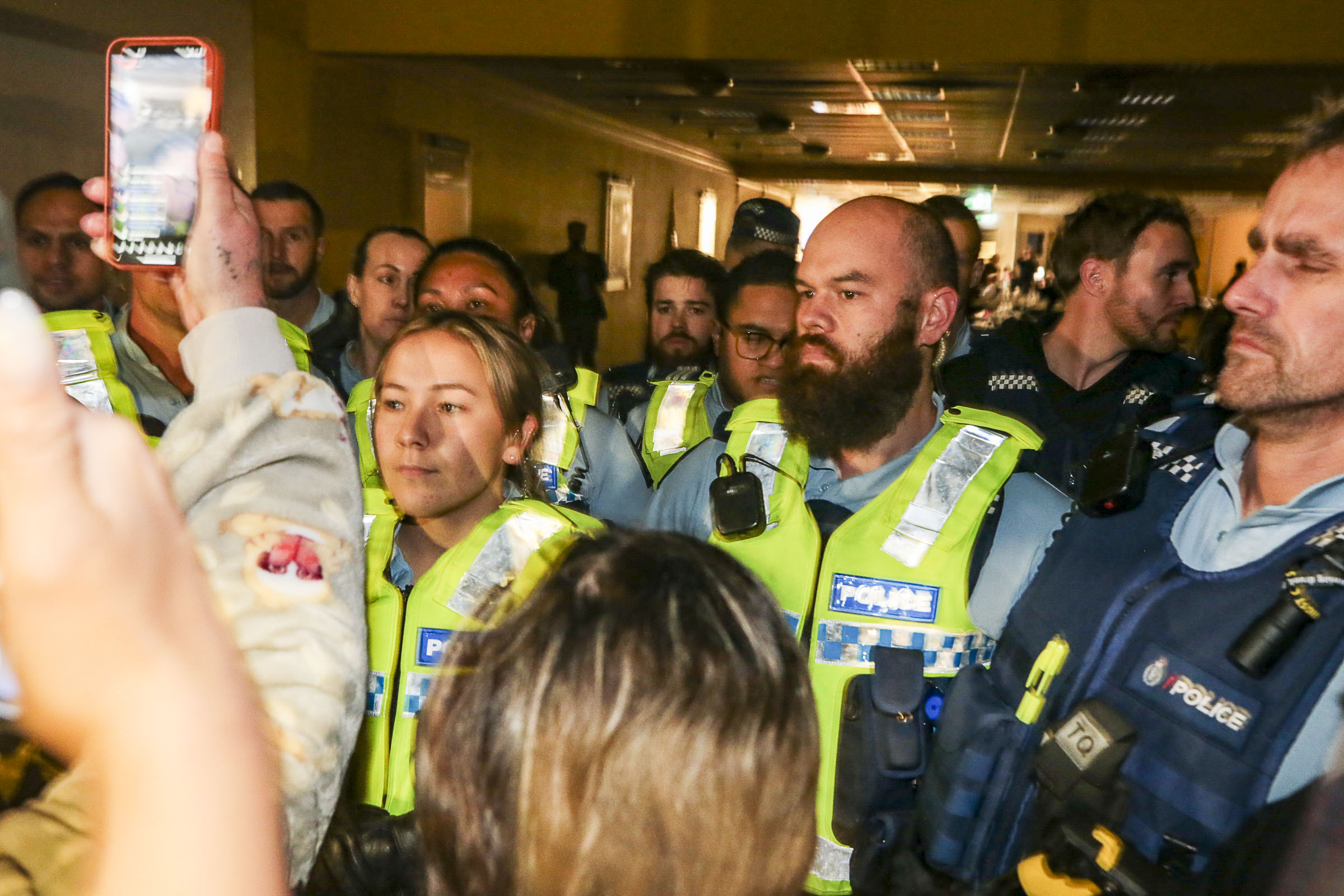 Police face protesters outside Julian Batchelor's Stop Co-Governance meeting in the Hastings CBD on Monday night. Several people were evicted and trespassed for disrupting the meeting, while two were arrested. Photo / Paul Taylor