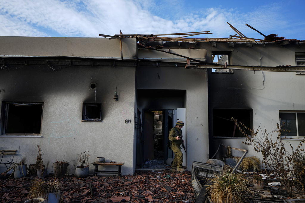 An Israeli soldier inspects a house damaged by Hamas militants in Kibbutz Be'eri, Israel on October 17. The kibbutz was overrun by Hamas militants on October 7. Photo / AP
