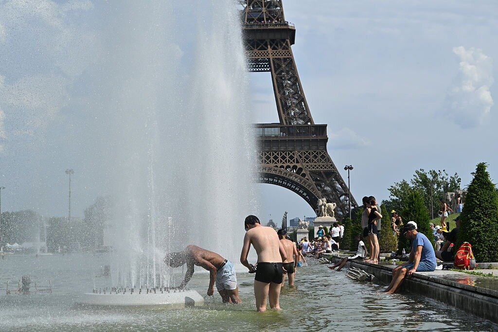 People cool off in the fountains of the Trocadero Gardens in Paris. Photo / Getty Images