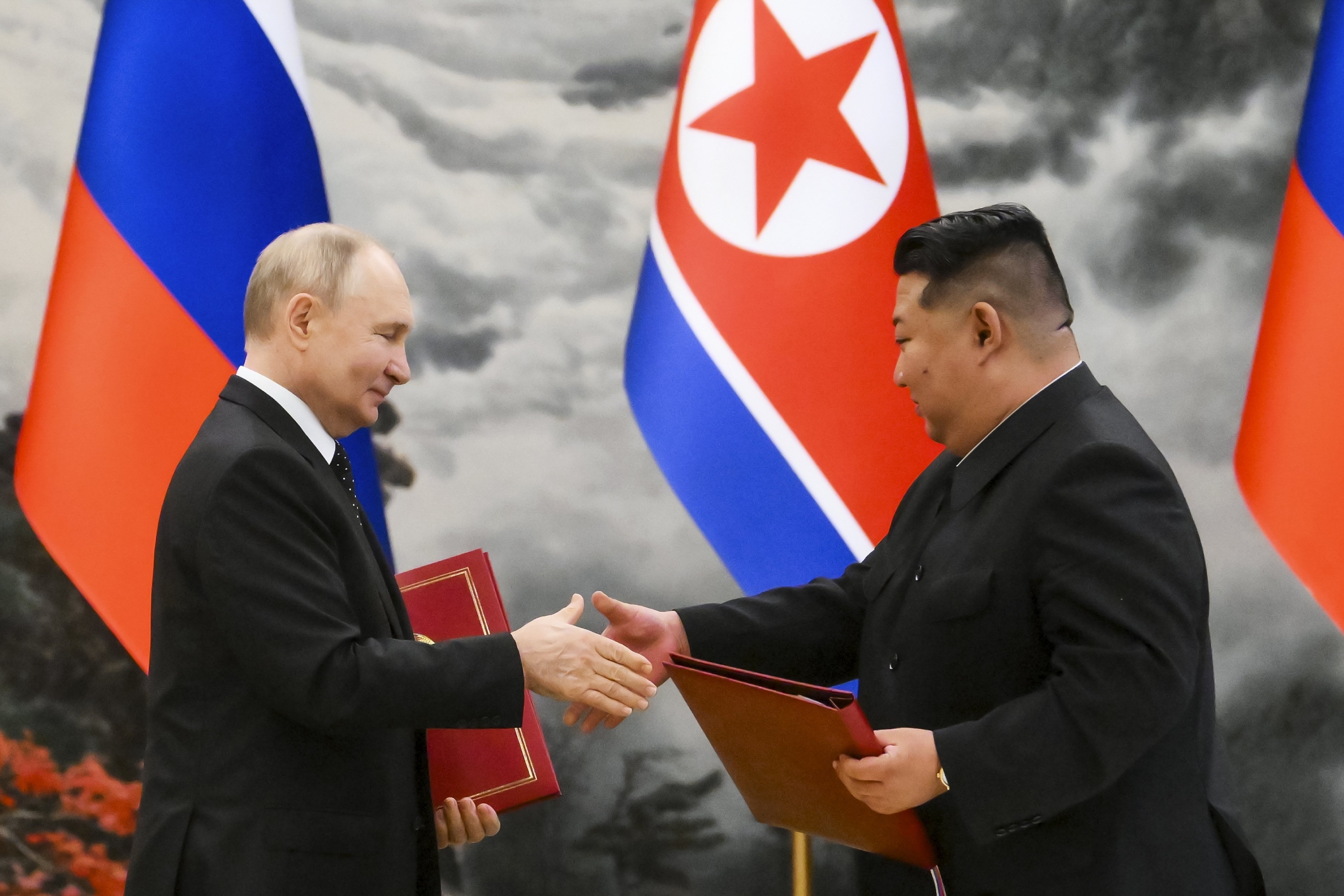 Vladimir Putin and Kim Jong Un exchanged documents during the signing ceremony of the new partnership. Photo / Sputnik, Kremlin Pool Photo via AP