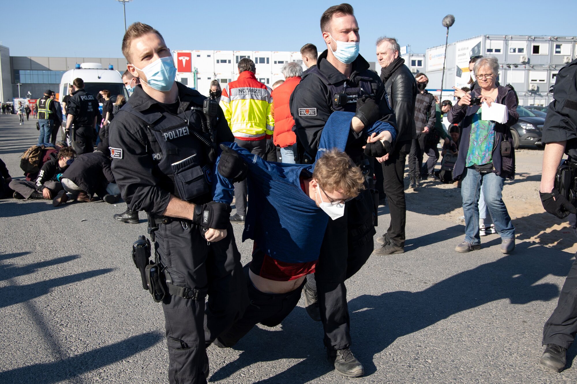 Police remove a protester blocking an entrance road during a demonstration against the environmental impact of the Tesla Gigafactory in Gruenheide, Germany. Photo / Bloomberg via Getty Images