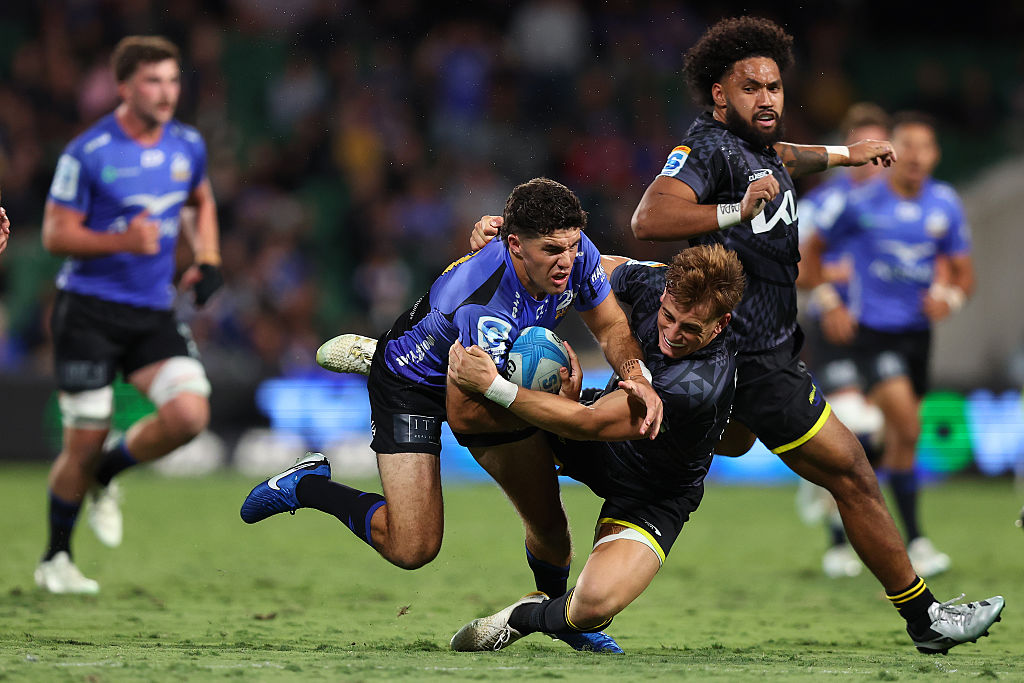 Ben Donaldson of the Force is tackled by Ruben Love of the Hurricanes. Photo / Getty Images
