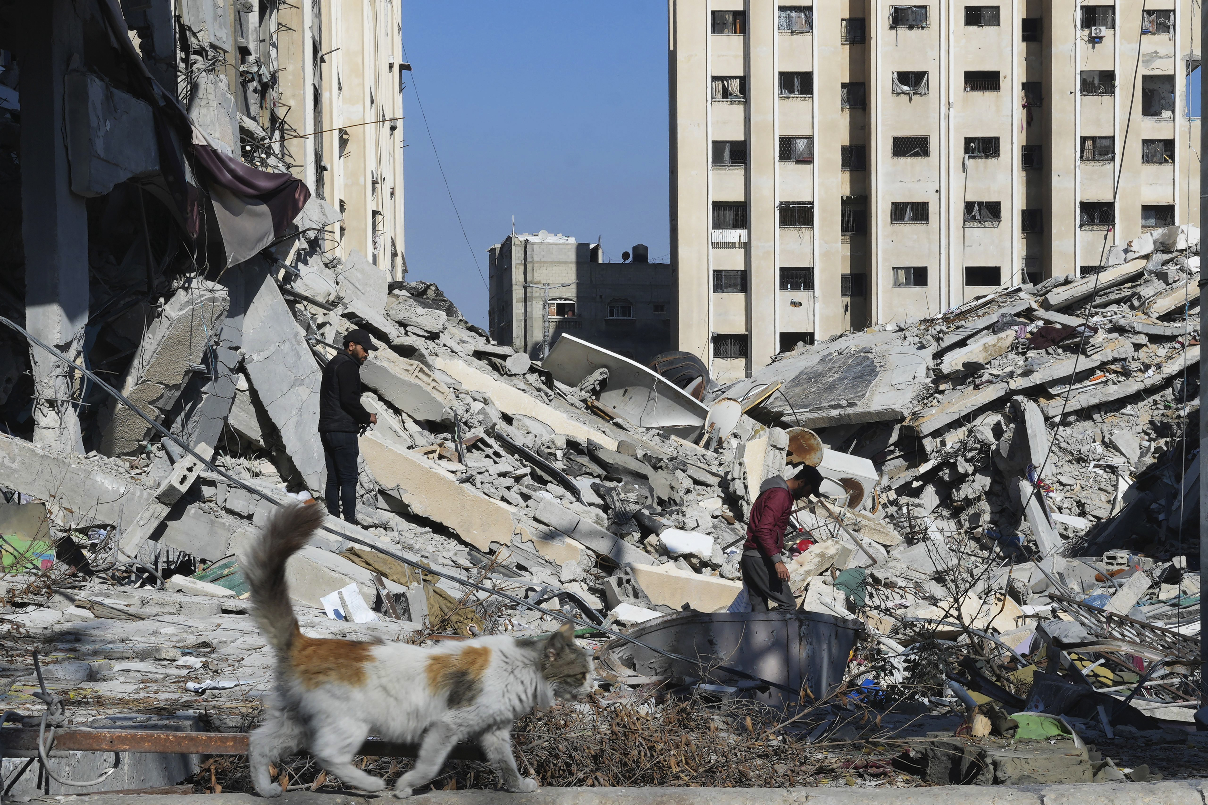 Palestinians walk through destruction from the Israeli bombardment in the Nusseirat refugee camp in Gaza Strip. Photo / AP