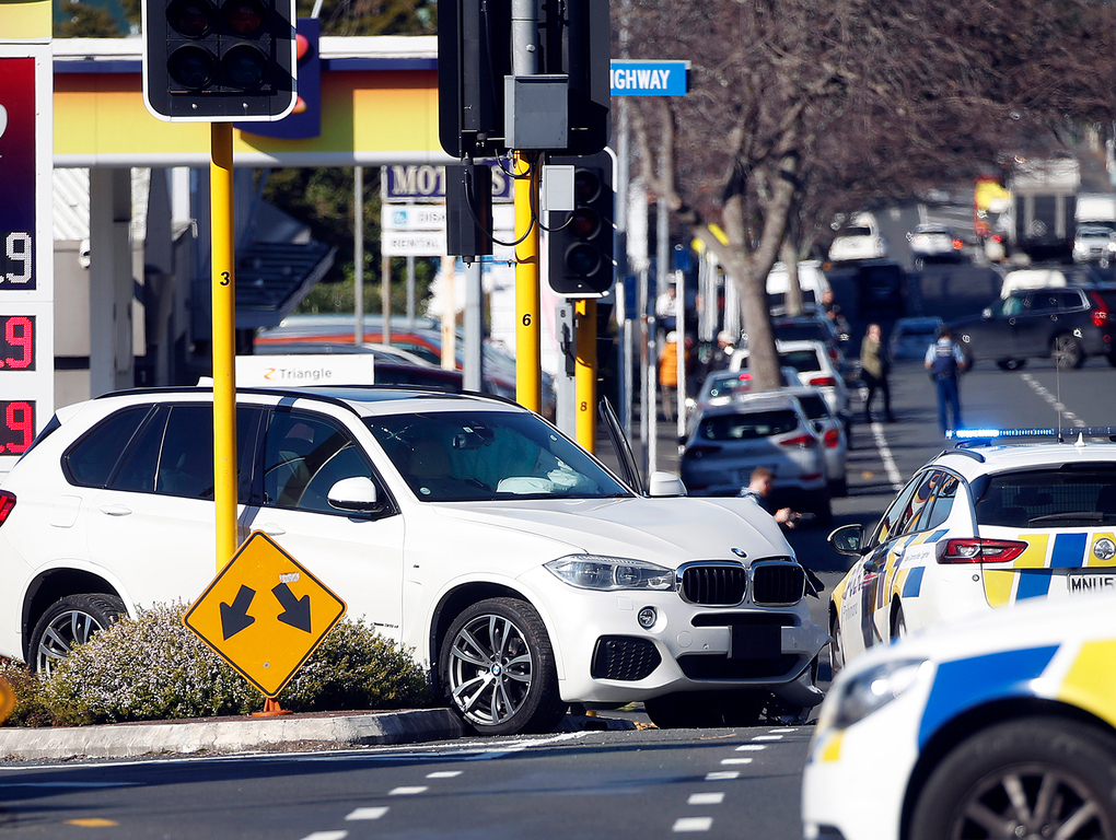 Armed police stand guard near a crashed BMW stolen from a car dealership on Great South Rd Greenlane. A man was arrested after several gunshots were fired. Photo / Supplied