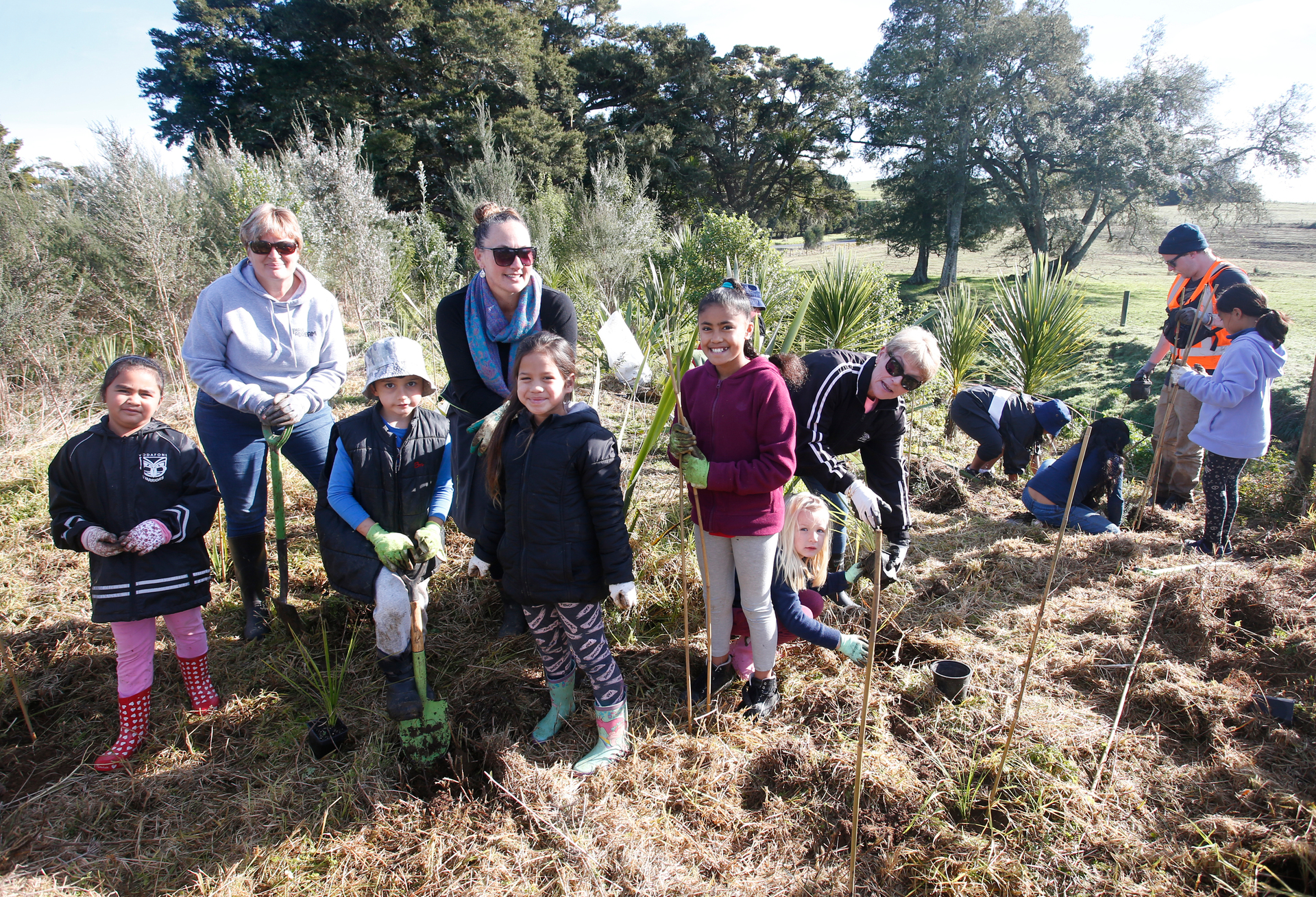 Engaging schools in environmental projects - like Totara Grove School students who plant trees - can help make a difference. Photo / Michael Cunningham