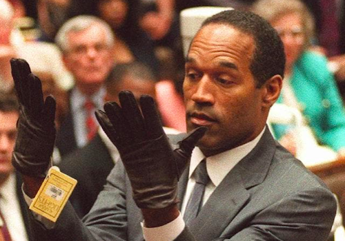 O.J. Simpson holds up his hands before the jury after putting on a new pair of gloves similar to the infamous