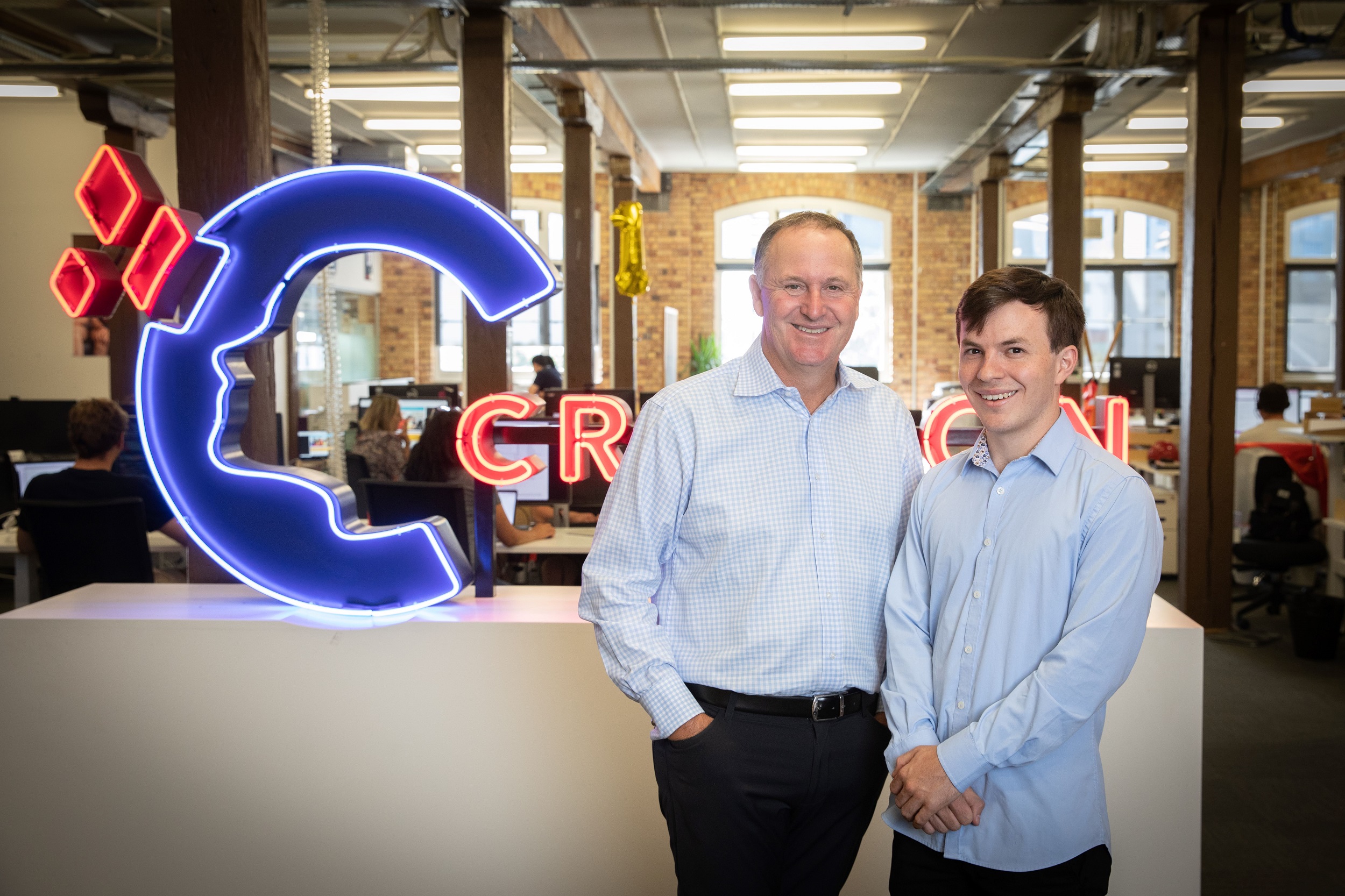 Crimson Education CEO Jamie Beaton (right) with advisory board member and minor shareholder Sir John Key, pictured at the edu-tech firm's Auckland office.