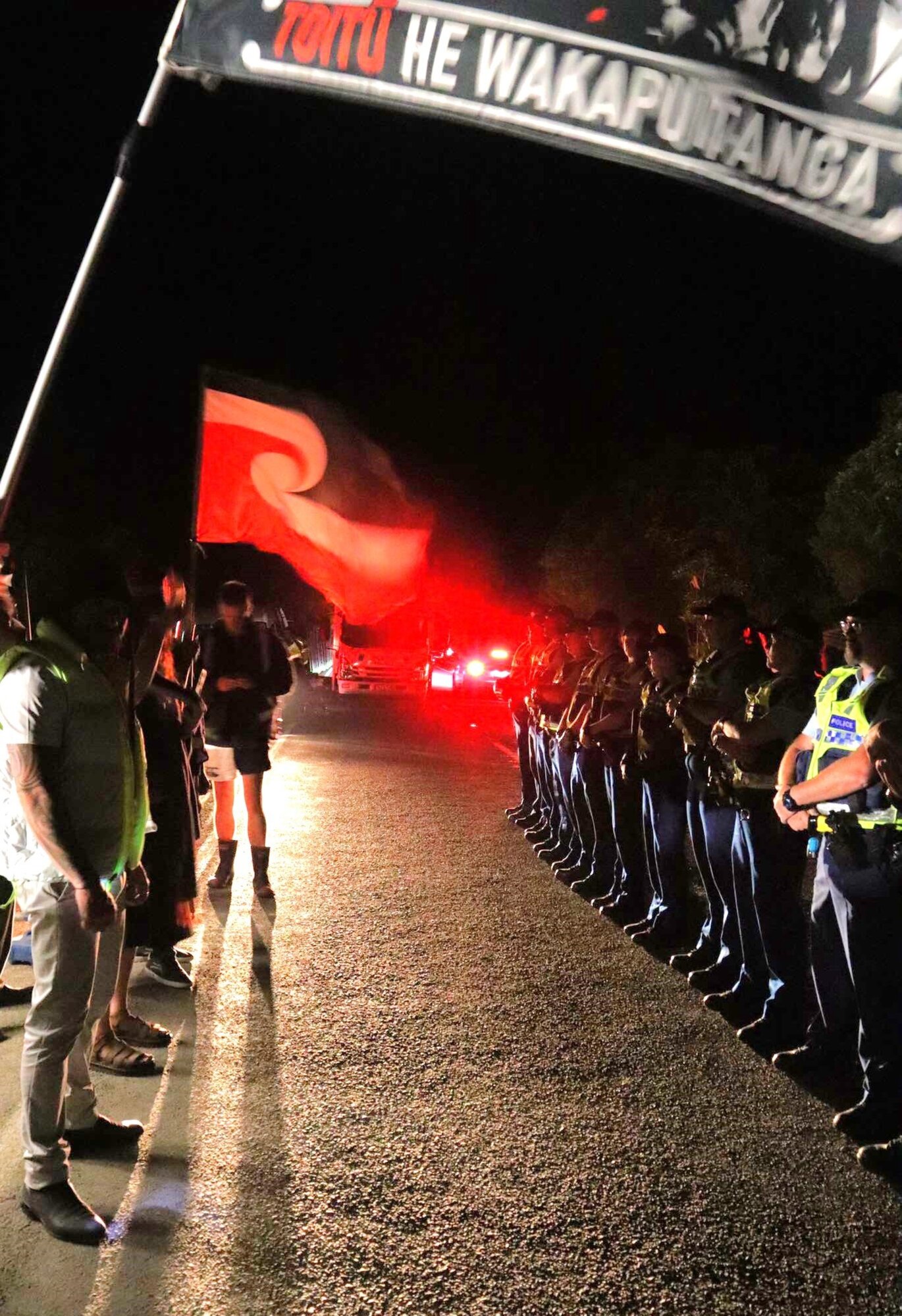 Protesters and police face off at the work site at Lake Rotokākahi where a controversial pipeline resumed overnight. Photo / Protect Rotokākahi