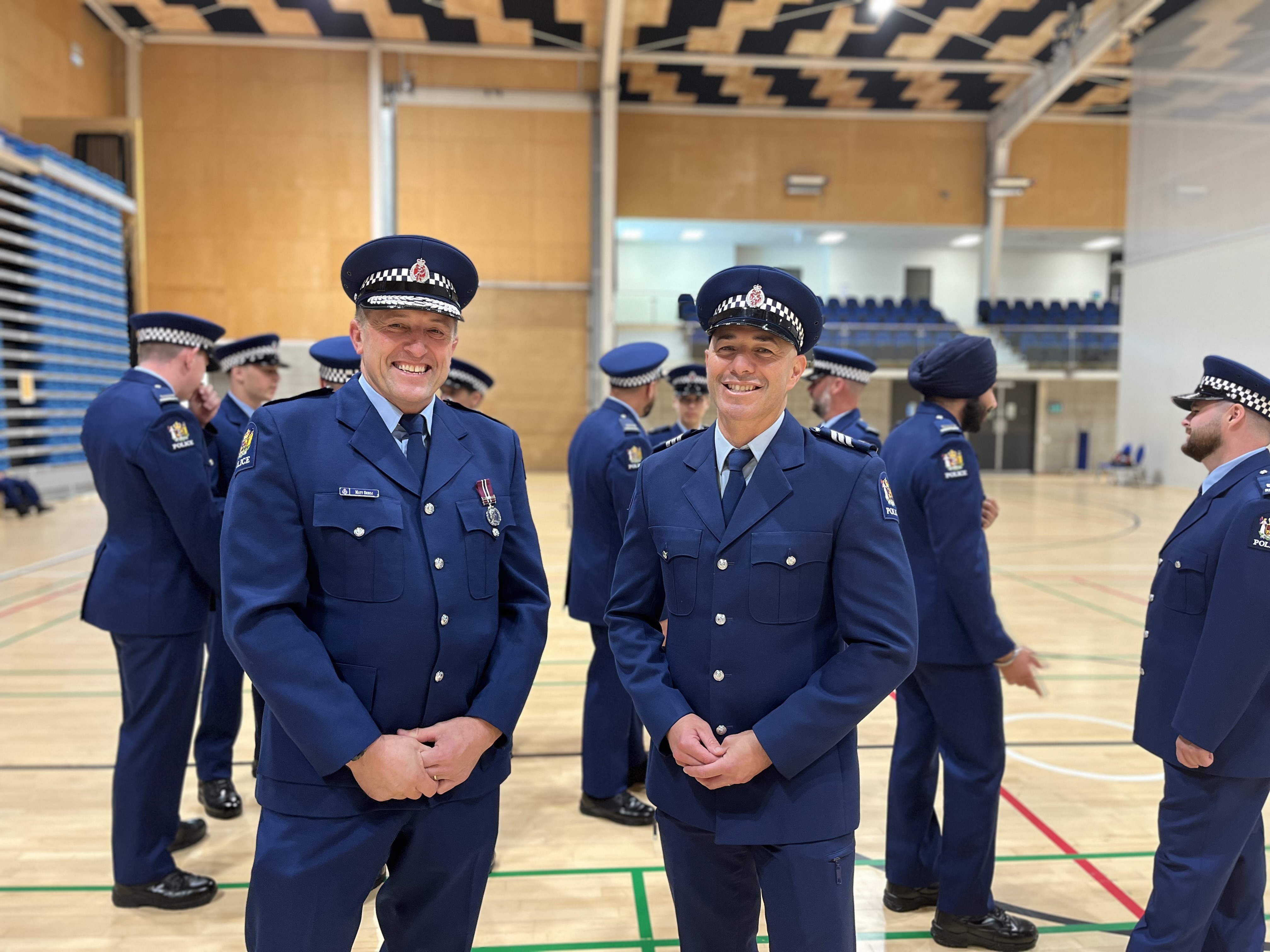 Superintendent Matt Srhoj, Police District Commander Northland stands with Recruit Sergeant Joe Te Ao. Behind them are the nine new police recruits heading to Northland.