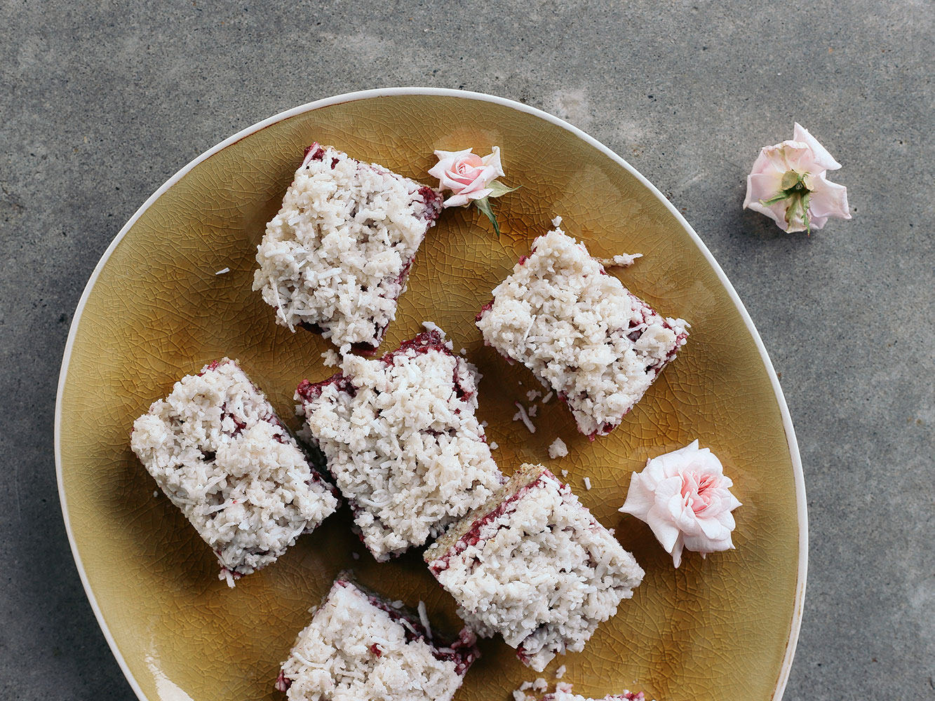 The sweet and nutty biscuit base is smothered with chia raspberry jam and a triple coconut topping. Picture / Eleanor Ozich