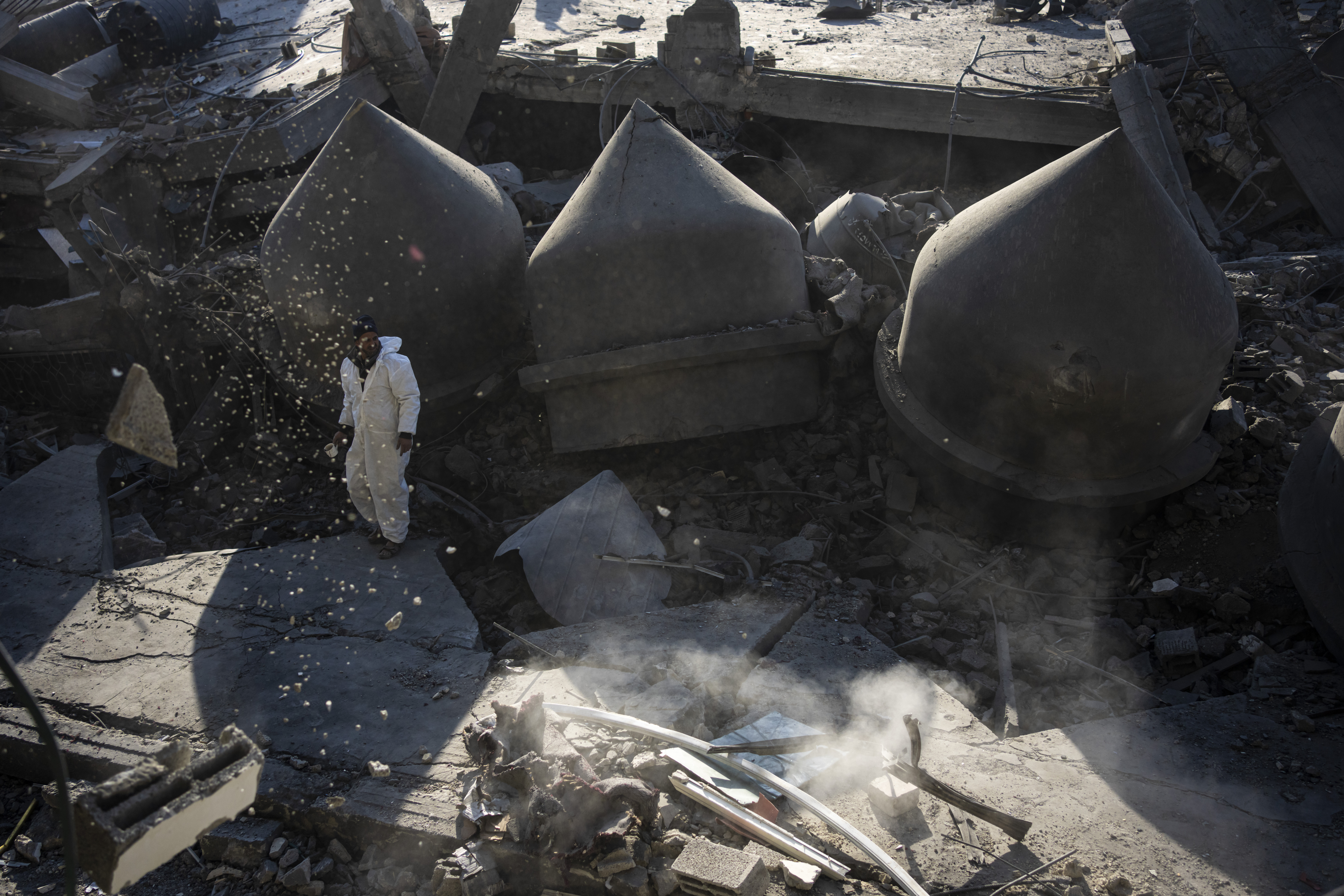 Palestinians look at the destruction after an Israeli strike on residential buildings and a mosque in Rafah, Gaza Strip. Photo / AP