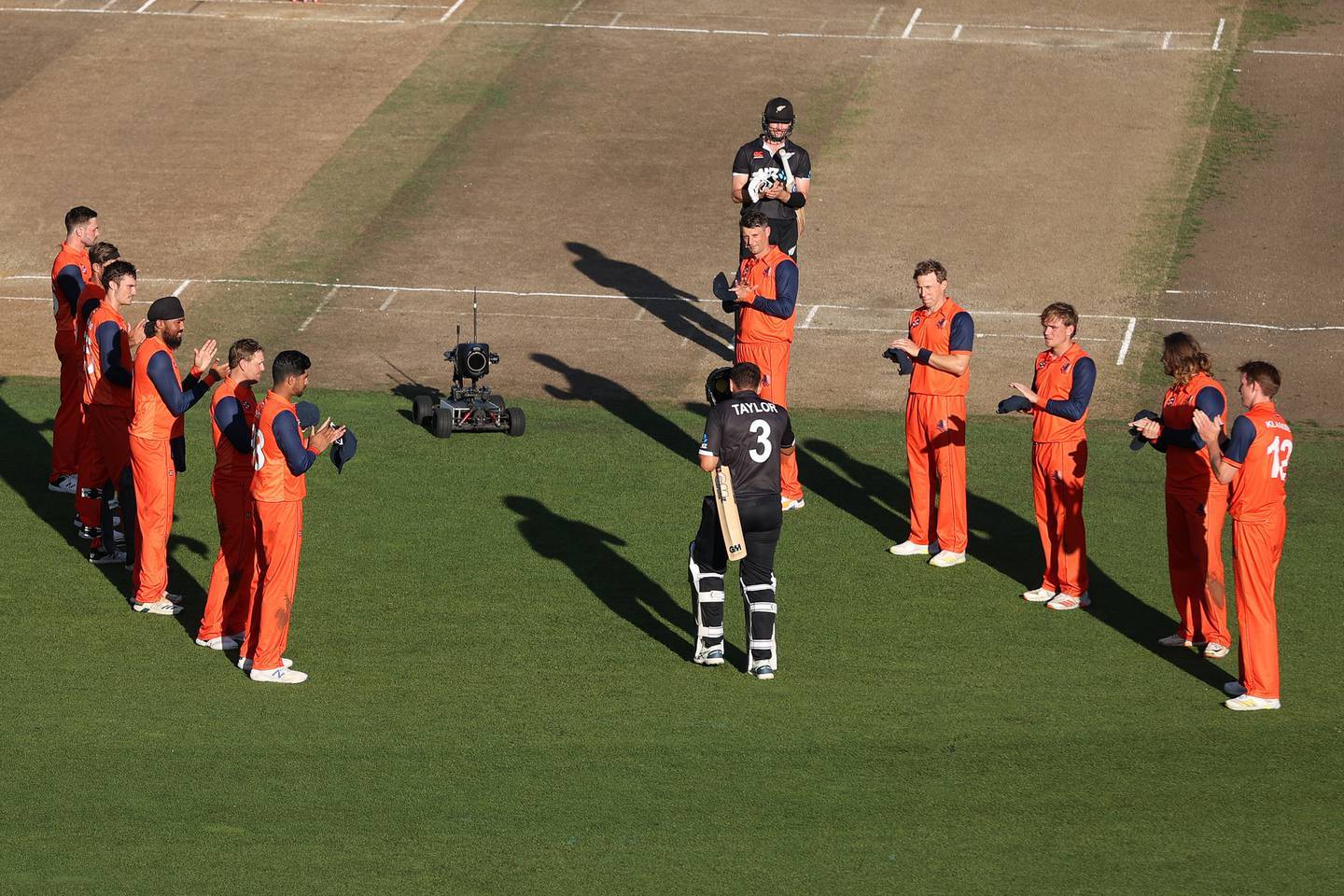 The Netherlands team form a guard of honour as Ross Taylor walks out to bat. Photo / Getty