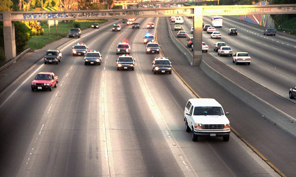 A white Ford Bronco, driven by Al Cowlings carrying OJ Simpson, is trailed by Los Angeles police cars as it travels on a freeway in Los Angeles. The pursuit was shown live on TV. Photo / AP