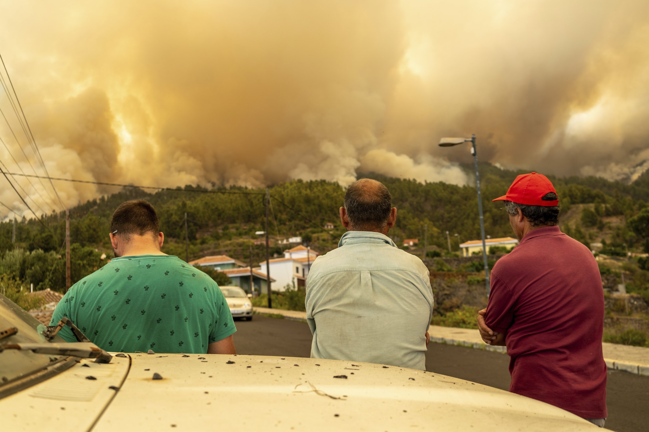 Local residents look on at a forest fire, near Puntagorda on the Canary Island of La Palma. The fire coincides with a heatwave that is hitting southern Europe. Photo / AP