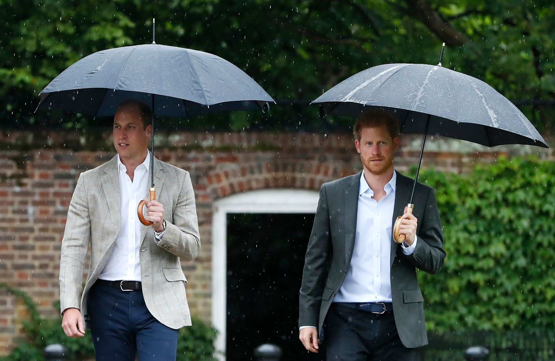 Prince William, left, and Prince Harry arrive for an event at the memorial garden in Kensington Palace, London. Photo / AP
