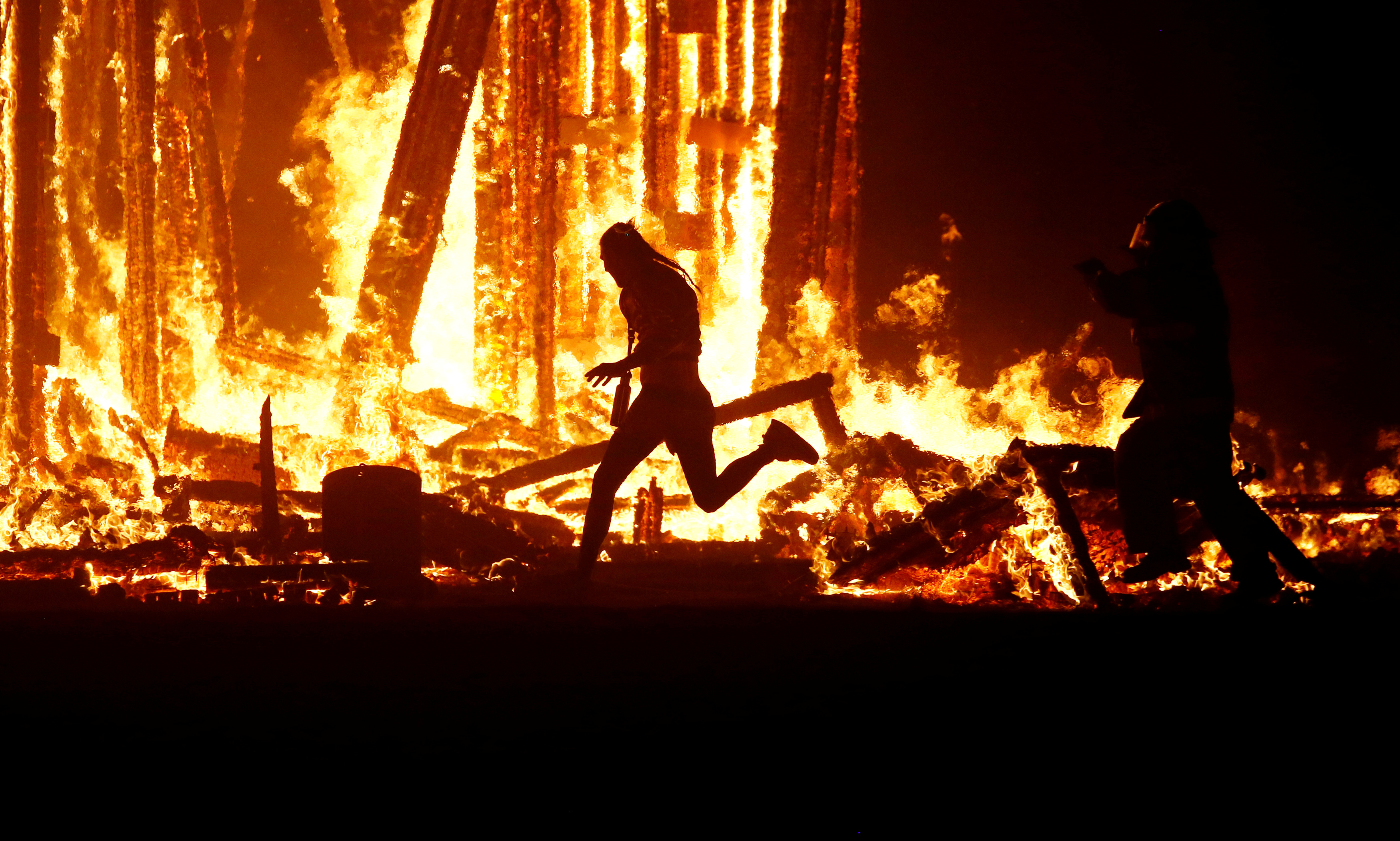 Stunned Burning Man festival-goers watch man run into flames - NZ Herald