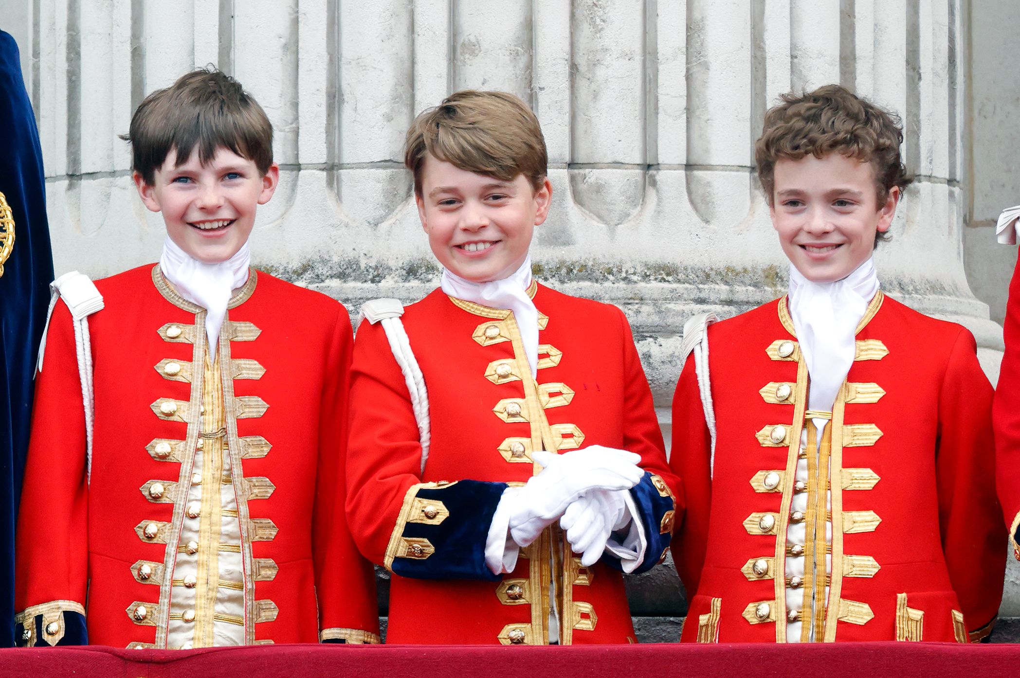 Page of Honour Ralph Tollemache, Prince George of Wales and Page of Honour Lord Oliver Cholmondeley watch an RAF flypast from the balcony of Buckingham Palace following the Coronation of King Charles III. Photo / Getty Images