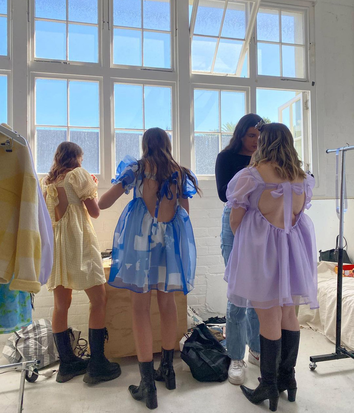Kayla on set at a Remnants photoshoot, where the designer and friends wear colourful Dumpling Dresses. 