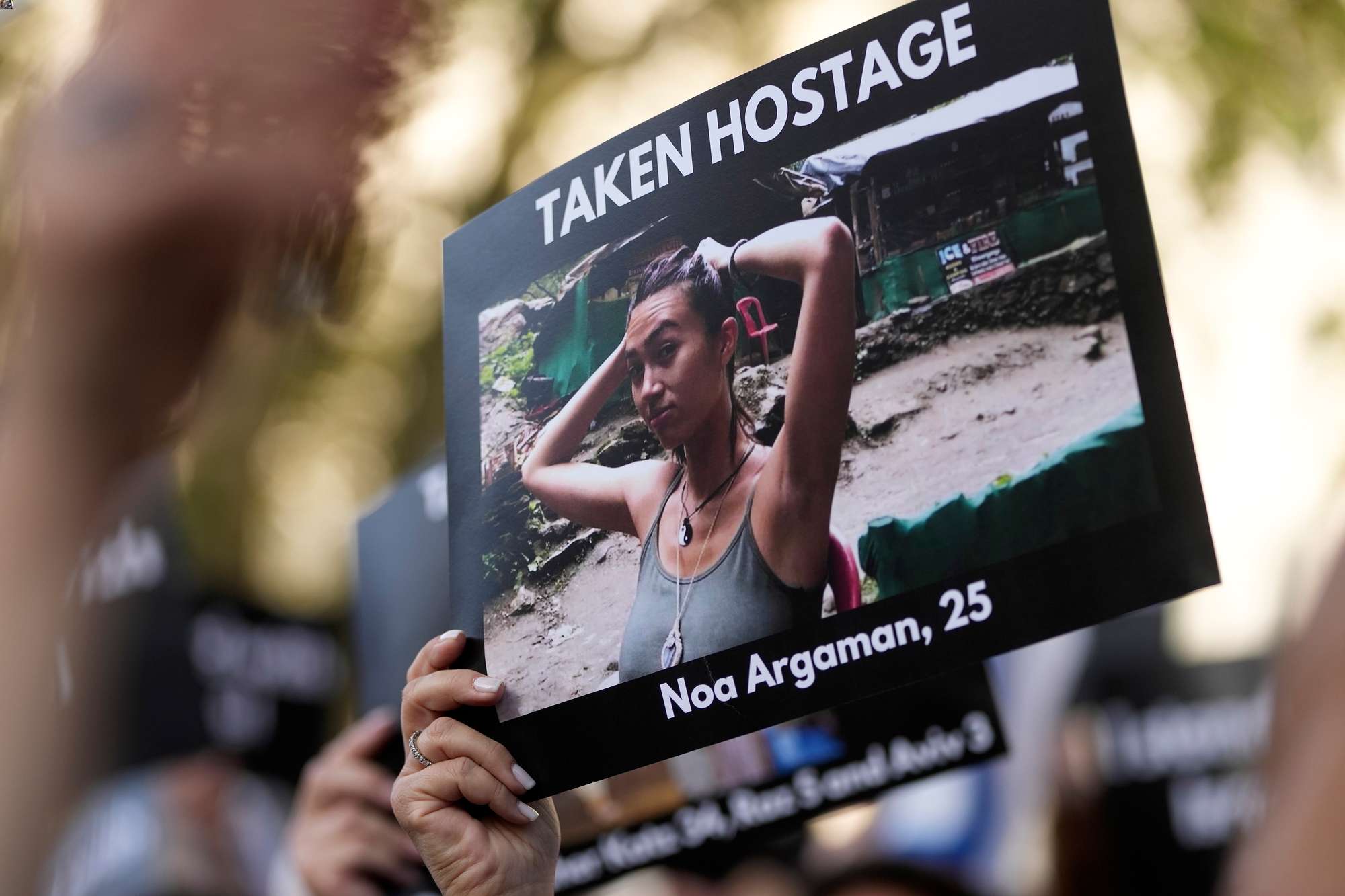 A photo held during the Jewish Community Vigil for Israel in London shows one of the people taken hostage by Hamas fighters. Photo / AP