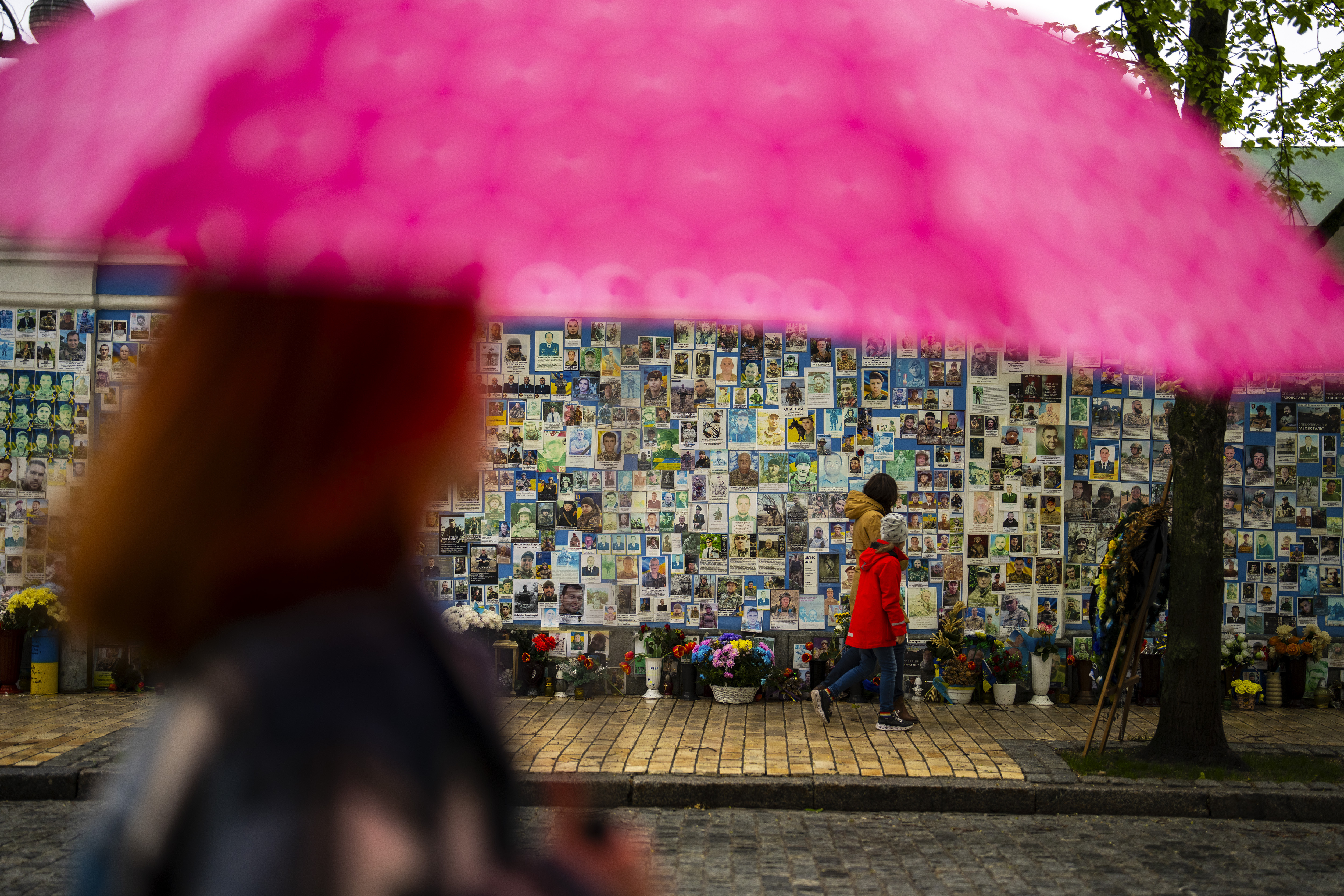 People walk past a memorial wall with photographs of Ukrainian soldiers killed during the war. Photo / AP