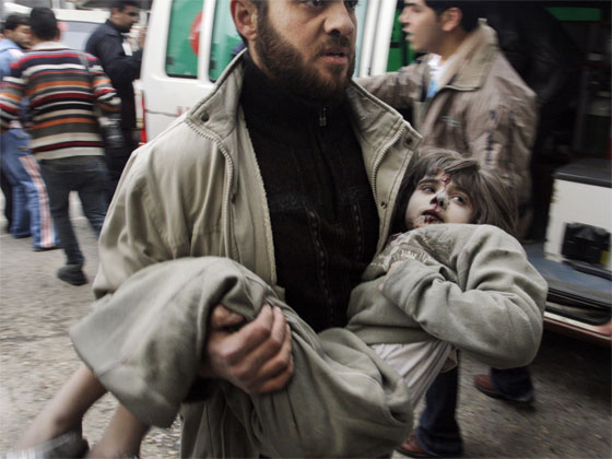 A Palestinian girl wounded in an Israeli missile strike is carried into the emergency area at Shifa hospital in Gaza City. Photo / AP