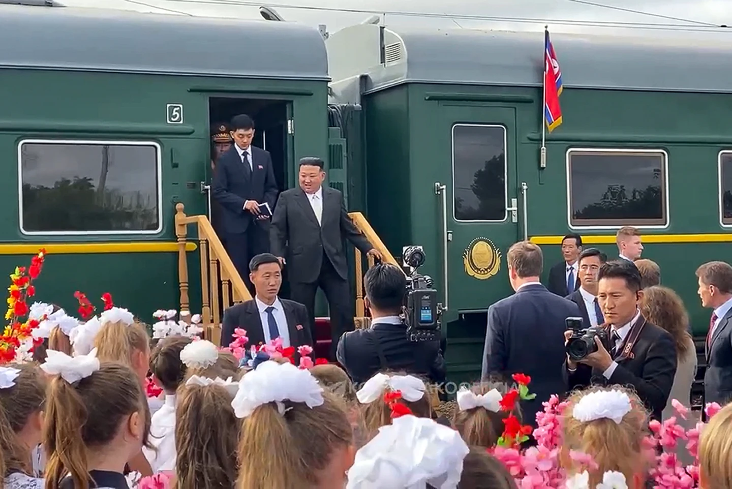 Children with flowers welcome Kim Jong Un as he steps down from his train in Vladivostok. Photo / AP