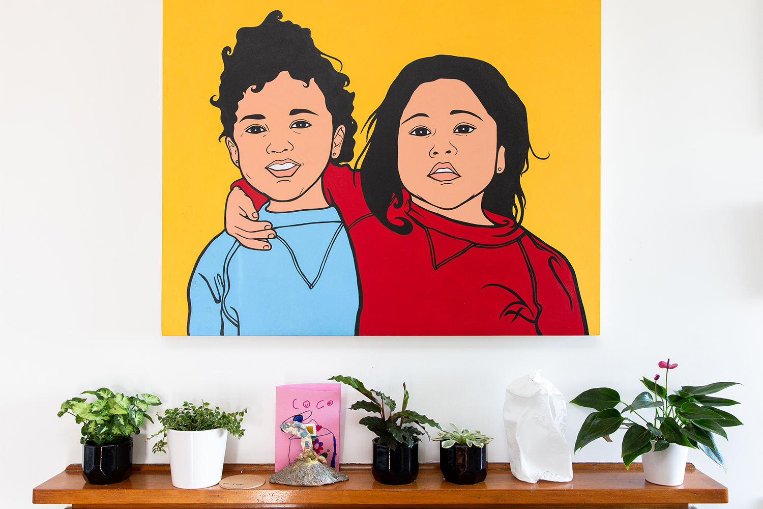 A painting by Courtney's cousin Danielle Meredith of them as children hangs in the lounge. Photo / Babiche Martens.