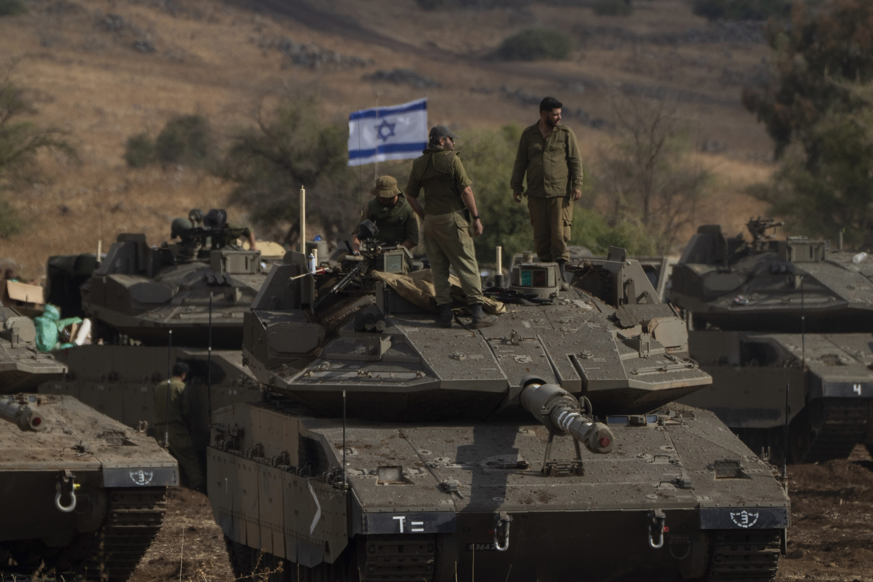 Israeli soldiers stand on the top of a stationed tank near the Israeli border with Lebanon. Photo / AP