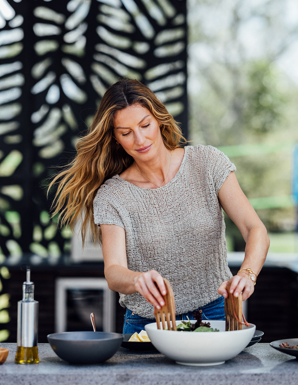 Bündchen prepares a salad at home. Photo / Rose Marie Cromwell, The New York Times